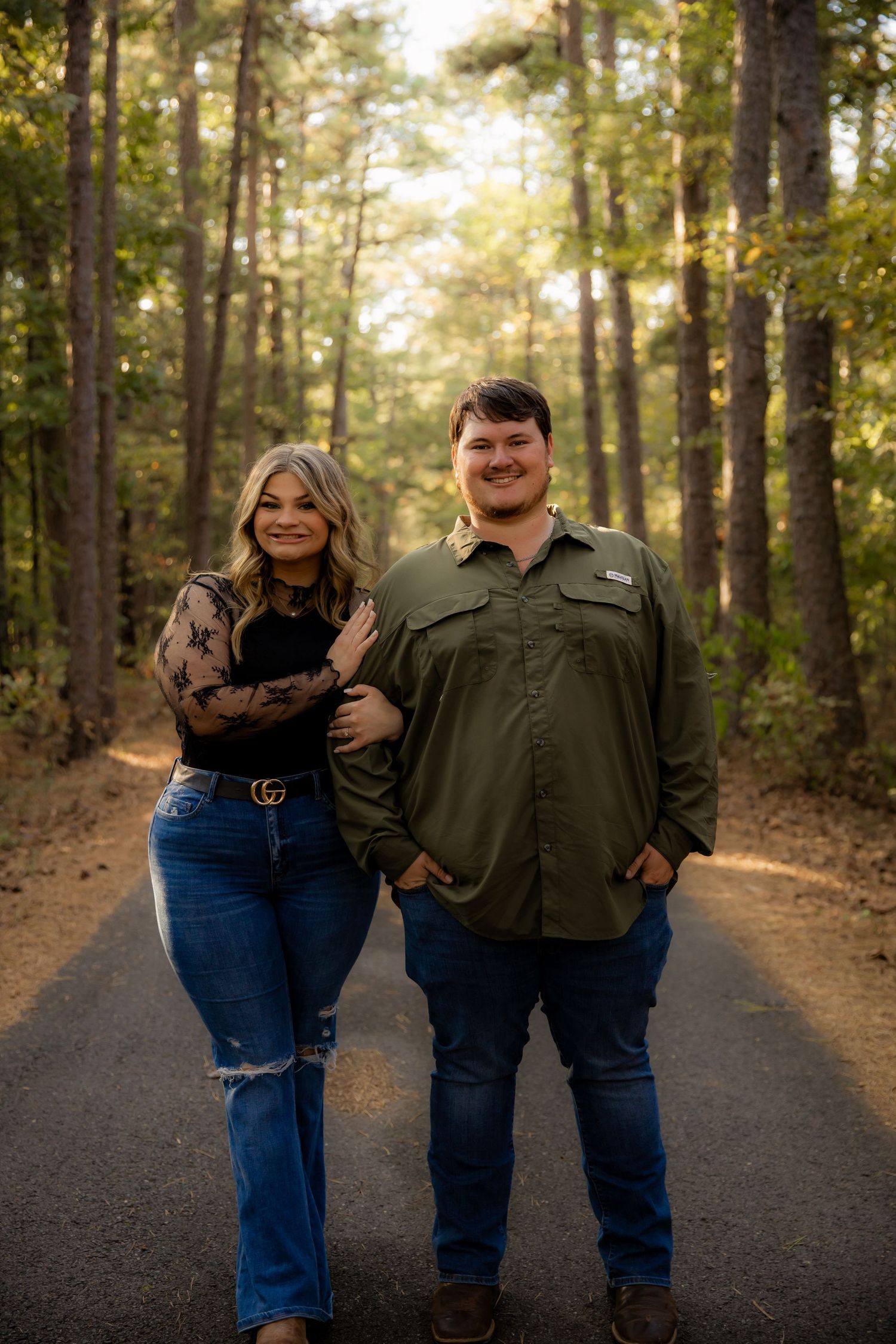 Holding boys arm and smiling at camera