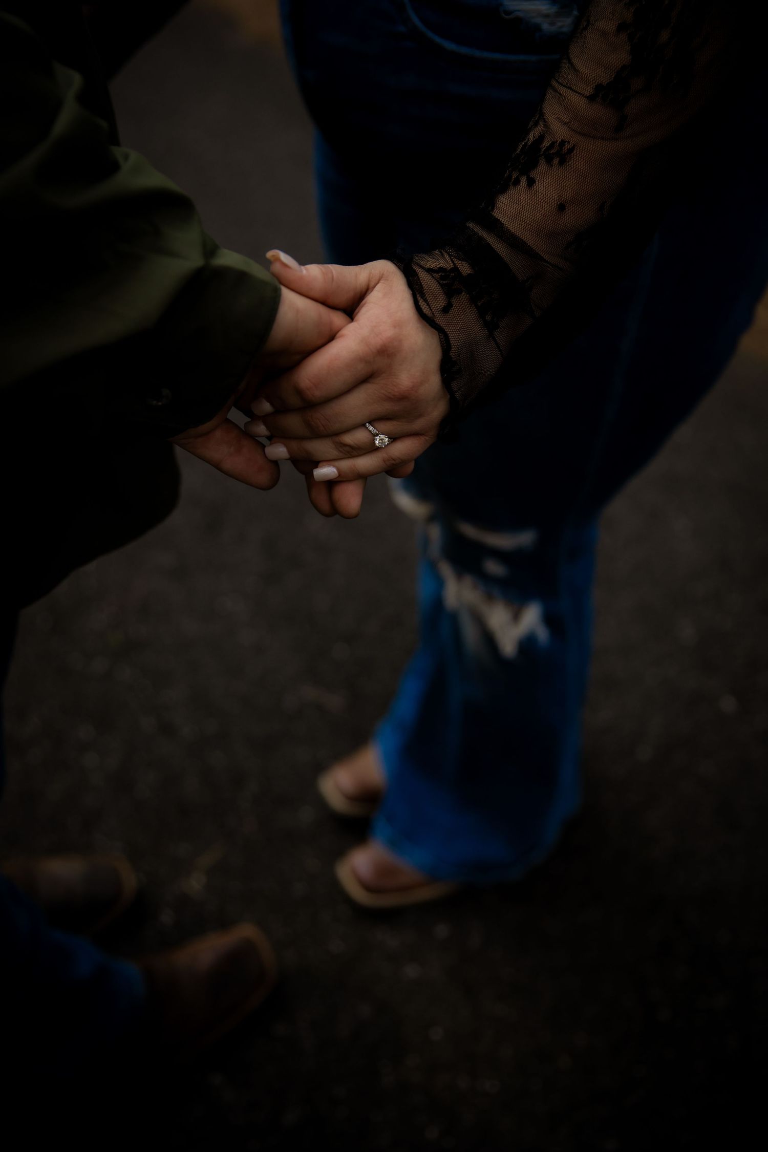 Highlight of hands holding and cowboy boots