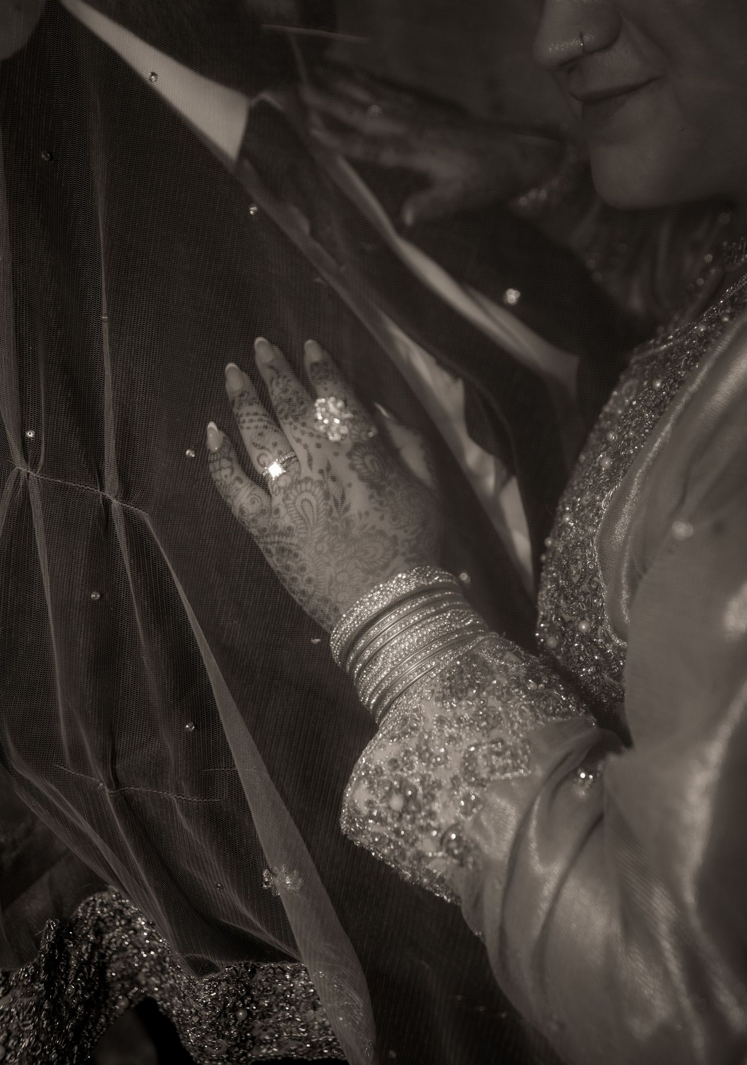 Husband and wife upclose show of hand on chest with engagement ring