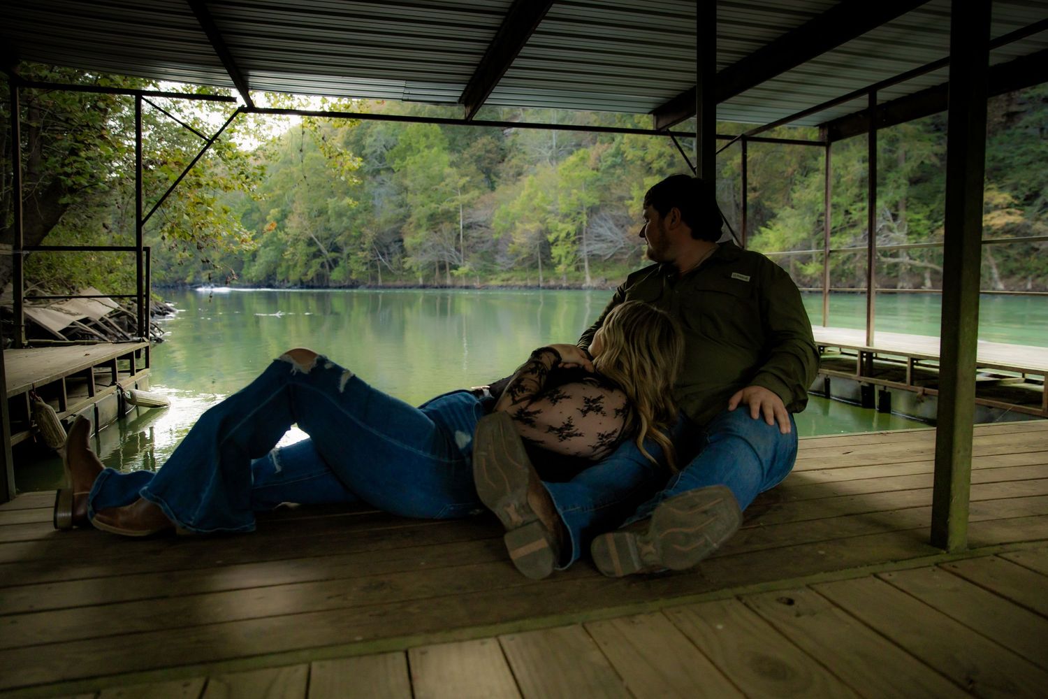 Couple laying on boat ramp looking out over river