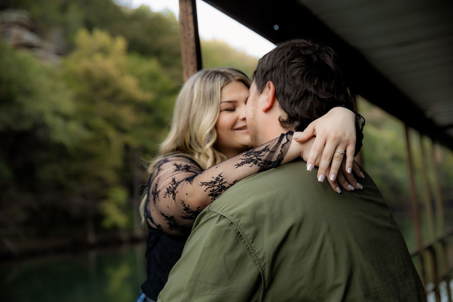 Couple with girl's arms around guys neck smiling