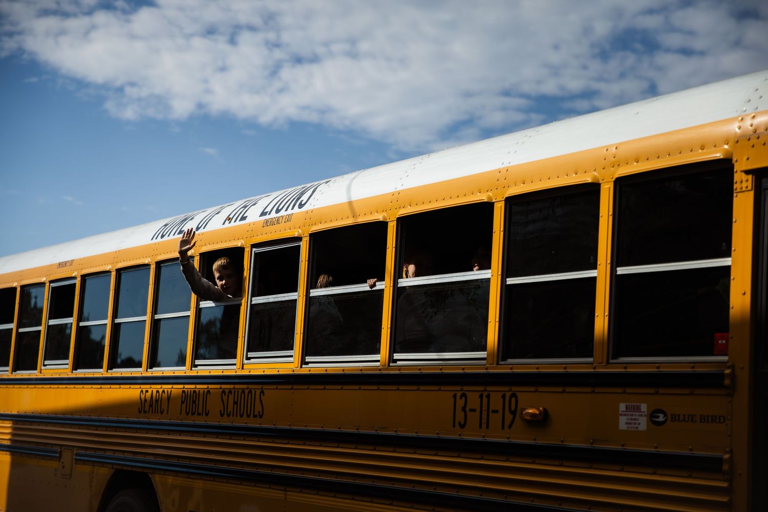 School bus with kid waving