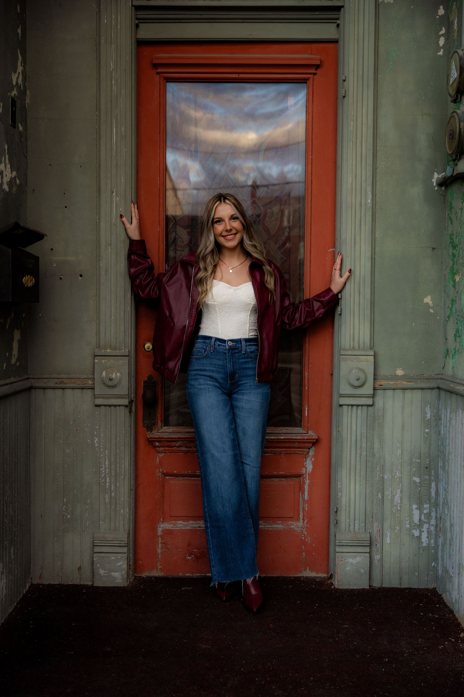 Girl in door way smiling at camera