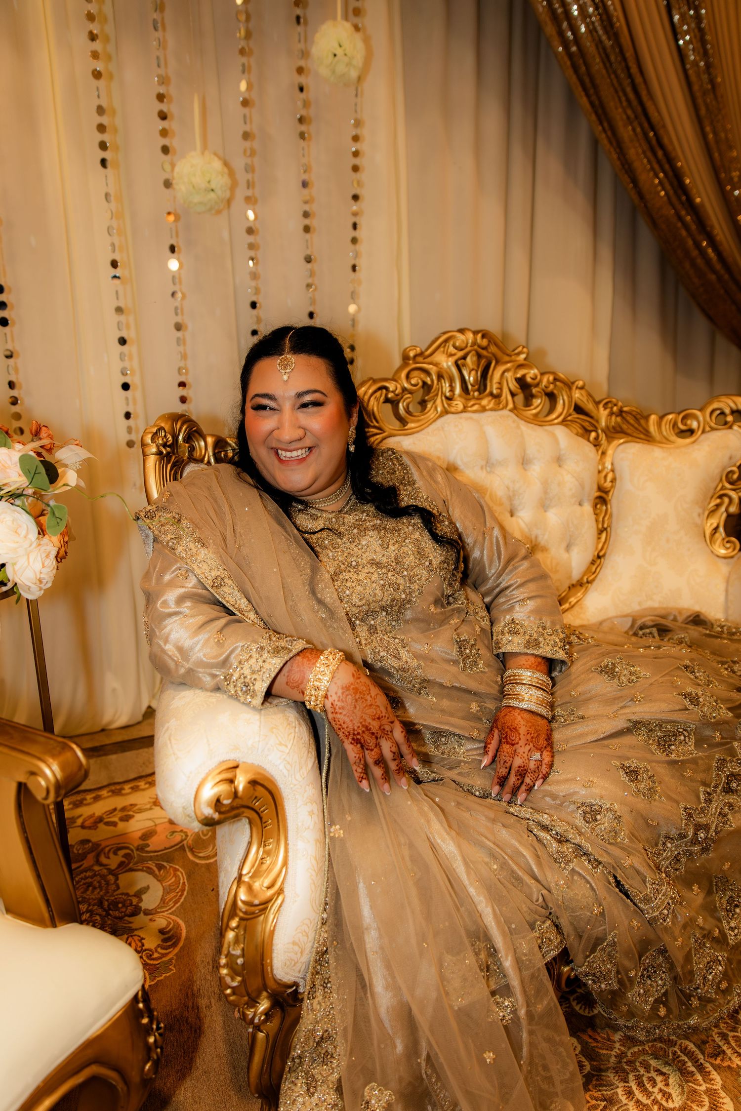 Bride smiling to side in chair
