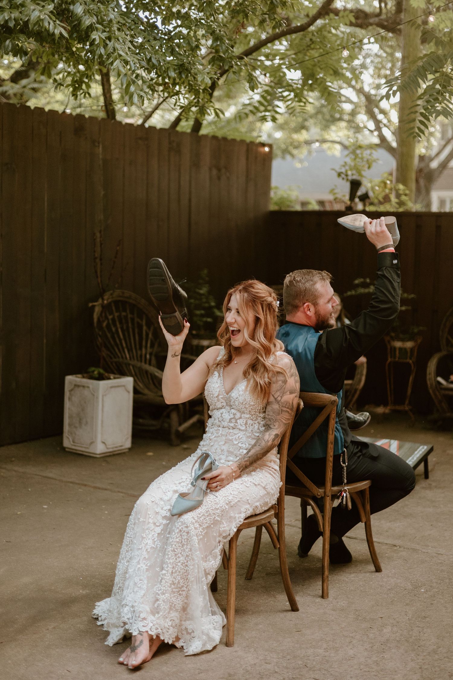 A playful wedding reception scene with vintage wooden chairs and casual atmosphere.