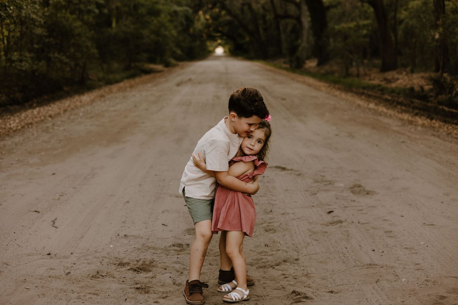 A series of candid family photos taken on a dirt path surrounded by Spanish moss draped trees.