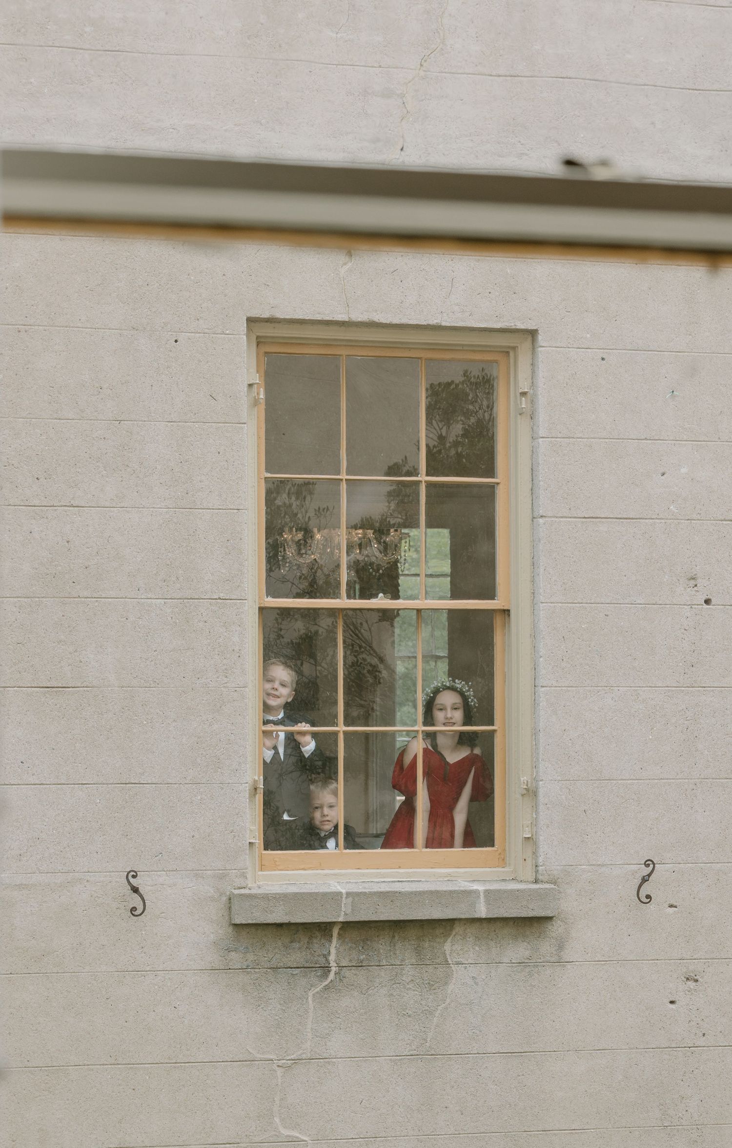 Vintage-style windows on a white concrete building with decorative elements visible inside.