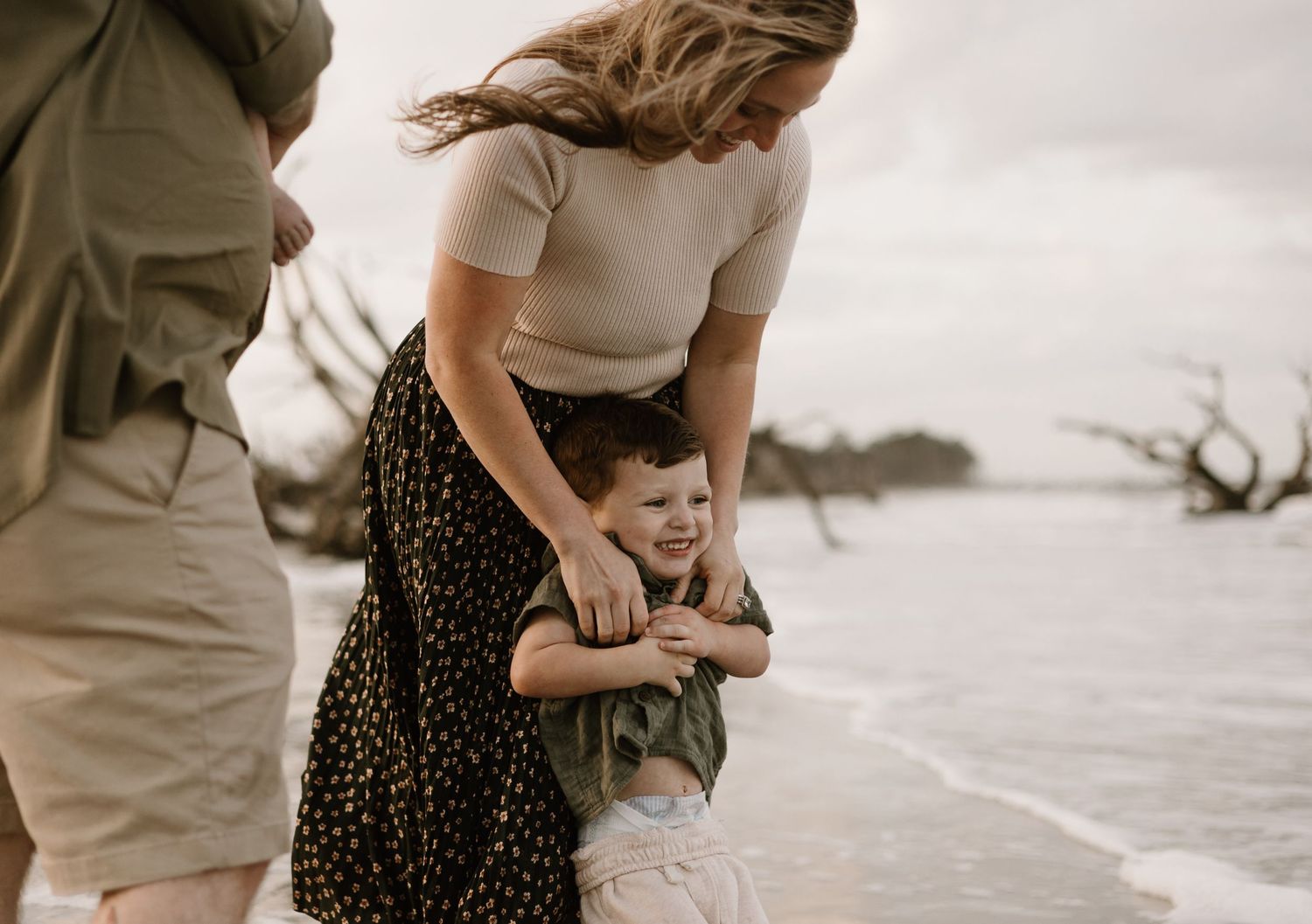 A couple shares tender moments together while walking outdoors.