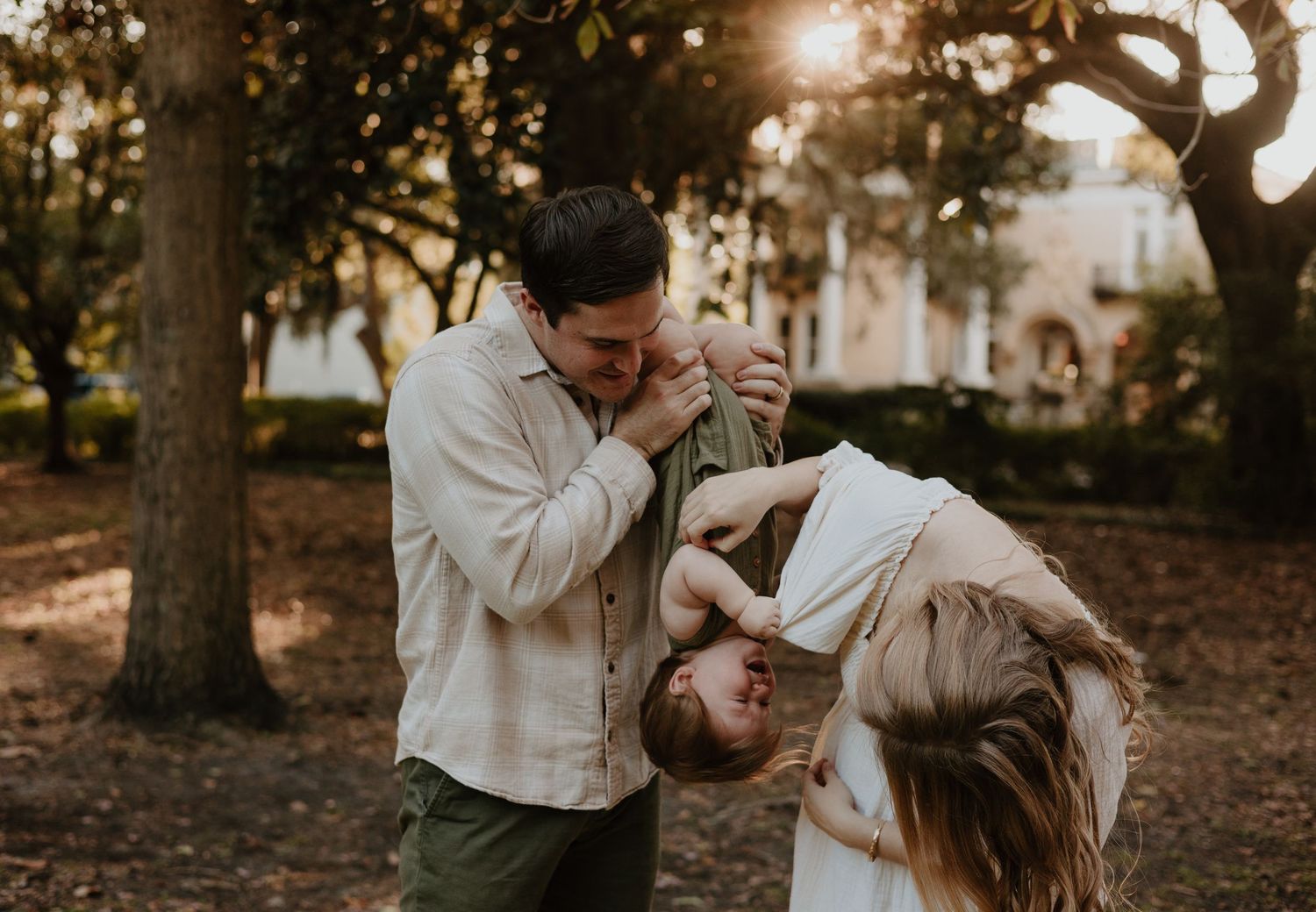 Couple embraces in a romantic outdoor photoshoot with golden sunlight filtering through autumn trees.