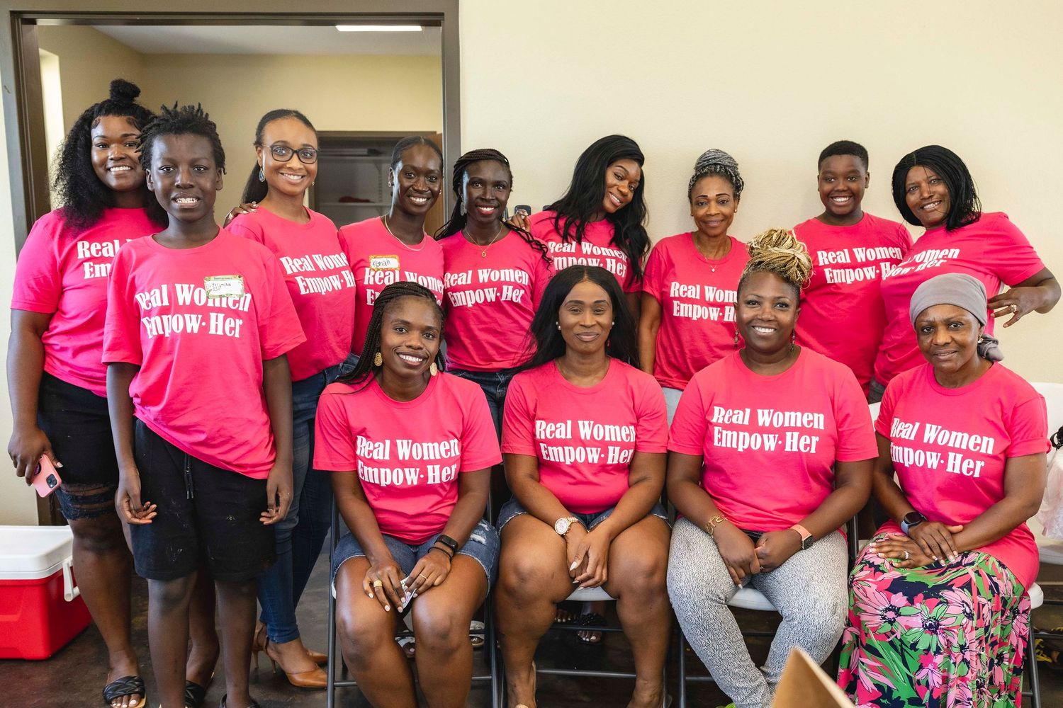 Group photo of people wearing matching pink t-shirts gathered for an event.