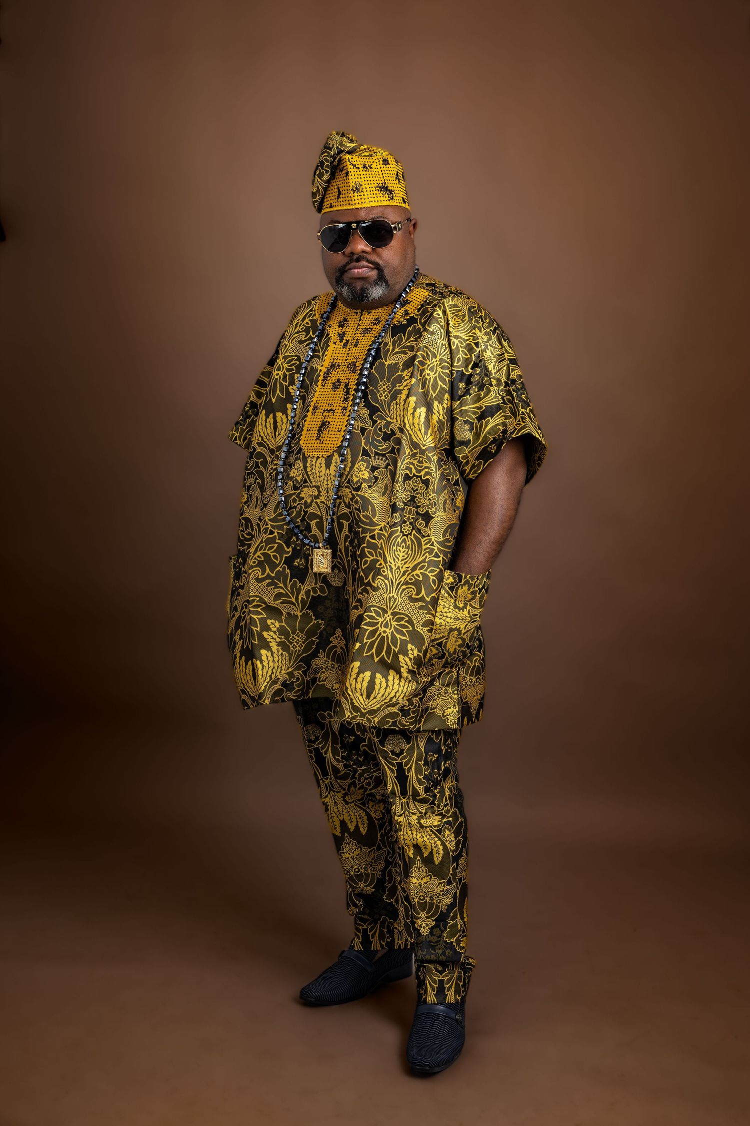 Fashion portraits featuring bold yellow and black patterned African attire and accessories.