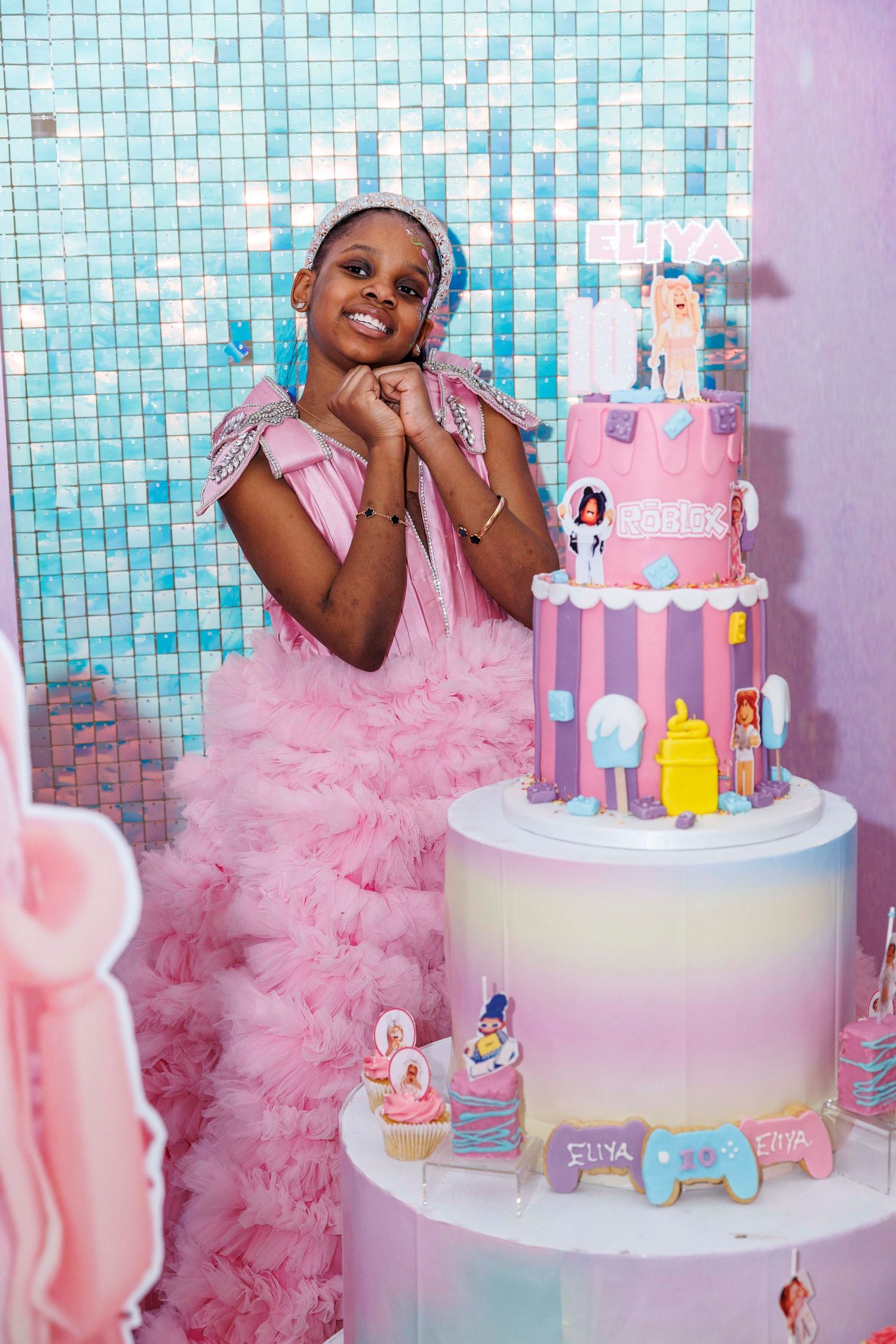 Pink princess themed birthday party setup with castle cake and tulle decorations.