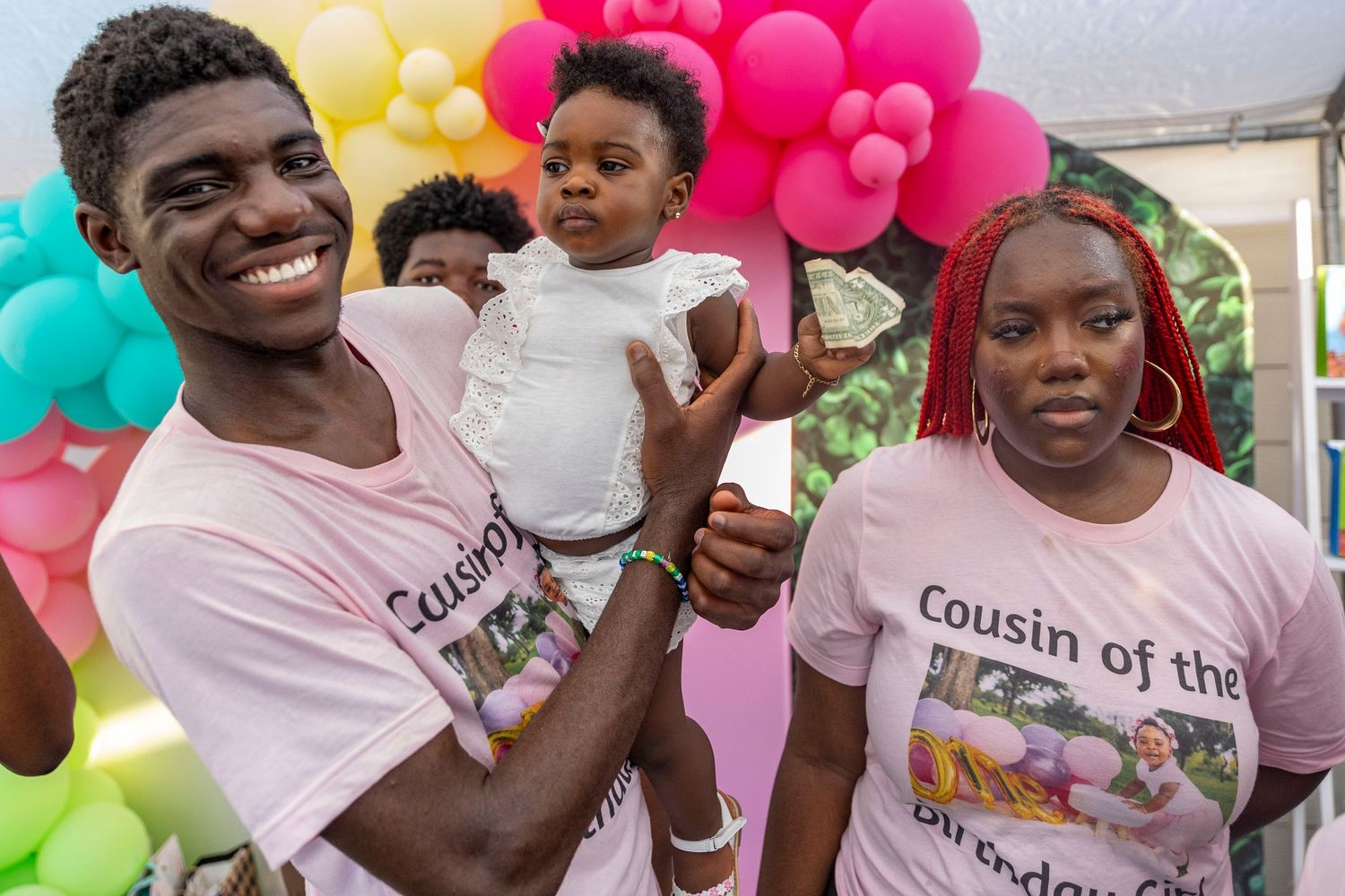 Birthday celebration with colorful balloon decorations and matching t-shirts for a special occasion.