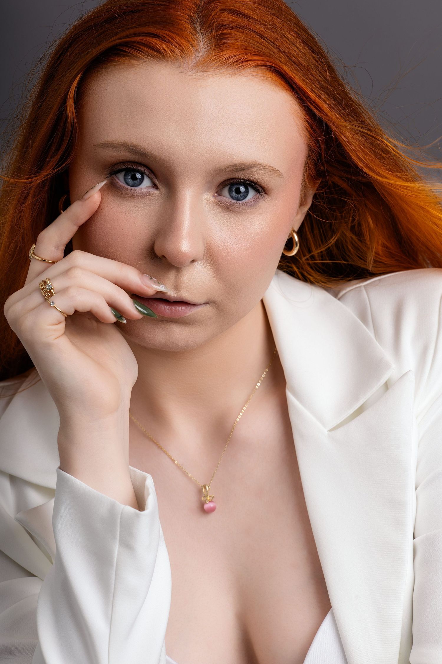 Close-up beauty portraits featuring a model in white blazer with crystal necklace.