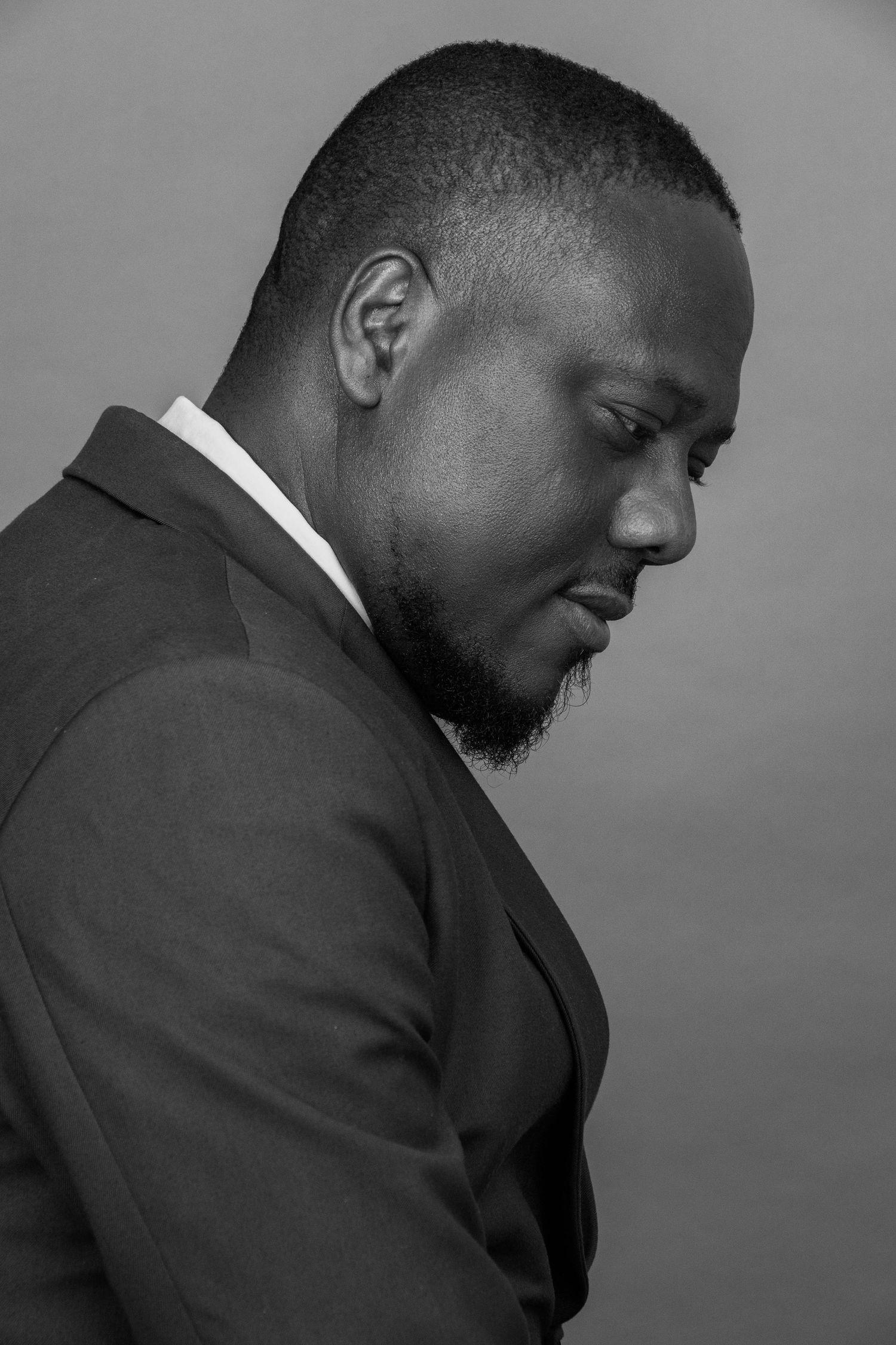 Dramatic black and white profile portraits in formal business attire.