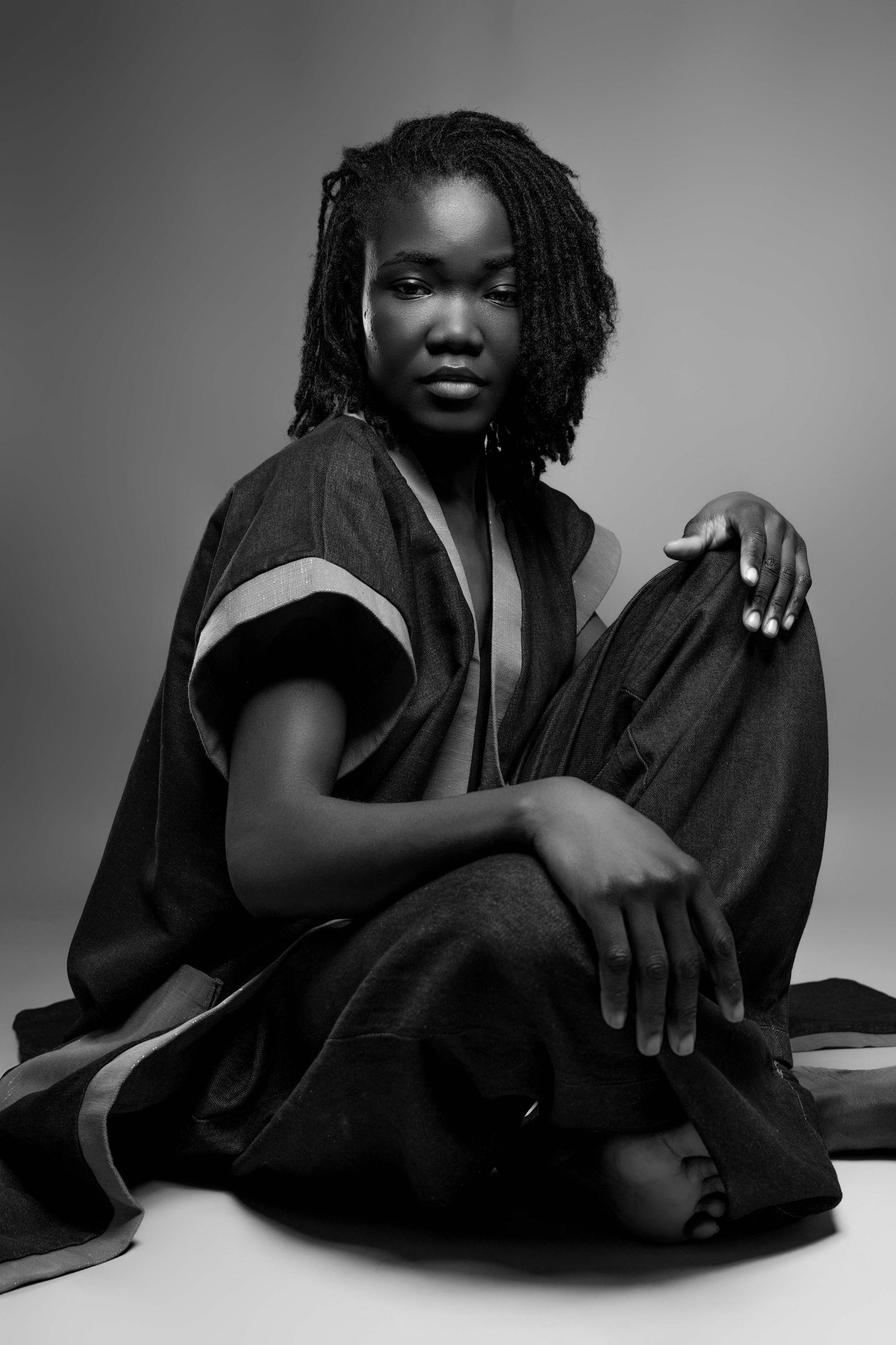 Artistic black and white fashion portraits showing dramatic poses on floor.