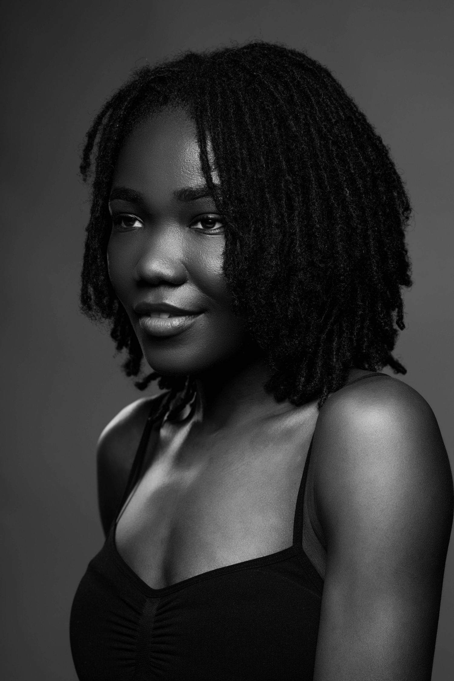 Dramatic black and white portrait series featuring natural hair and confident poses.