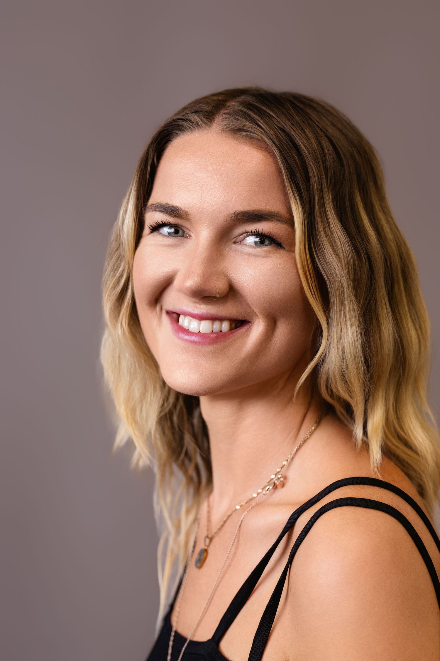 Portrait series showing joyful expressions and blonde hair against a neutral studio background.