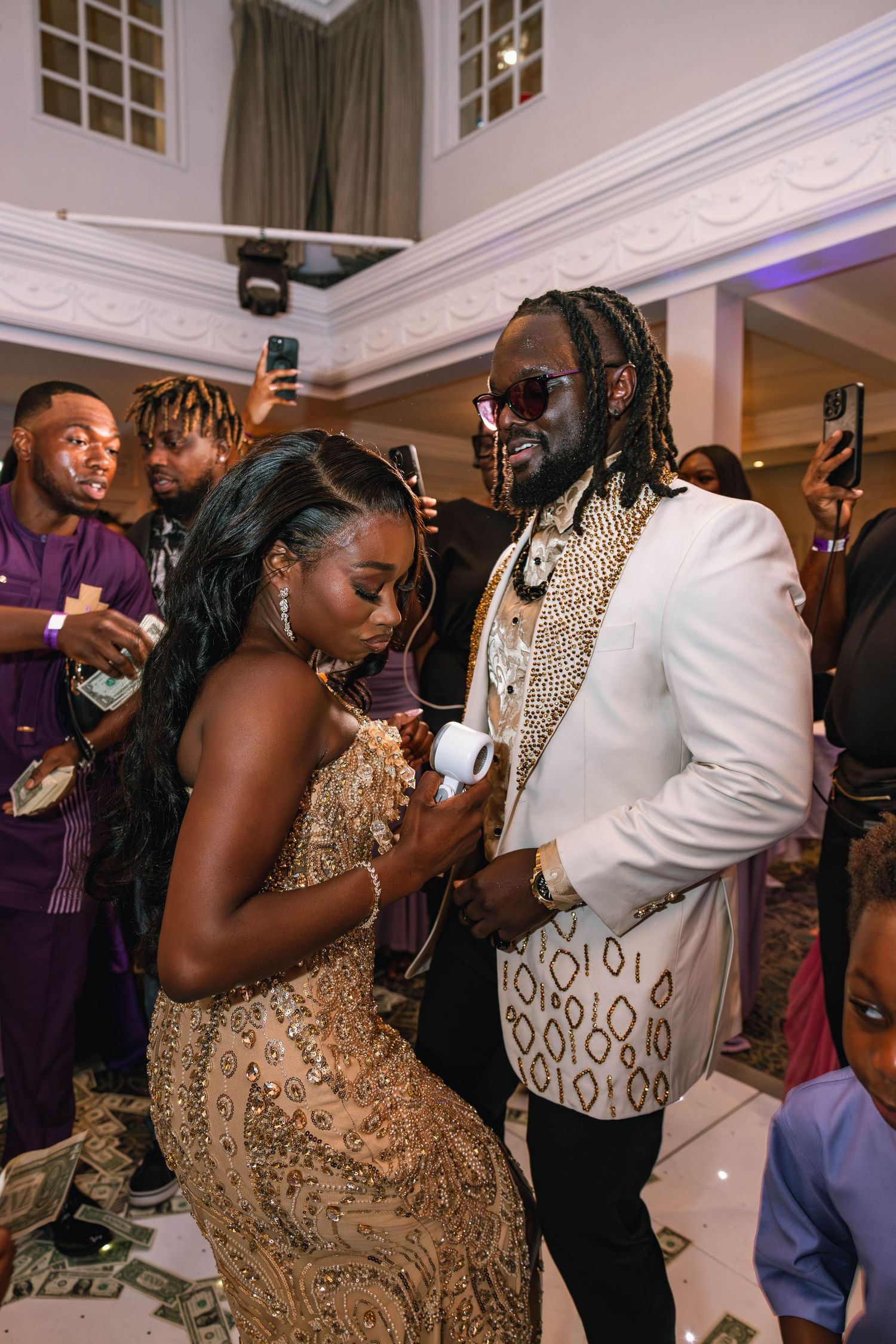 Wedding reception dance floor moments with guests in formal attire.