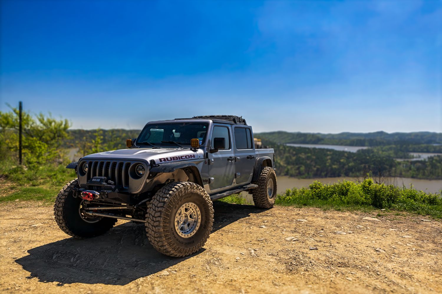 Custom Jeep Gladiator positioned on overlook with scenic valley view.
