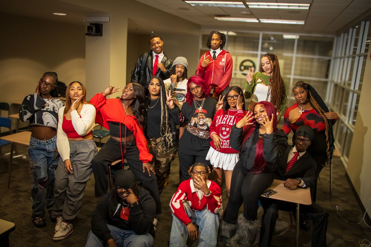 Group of young people posing together in a hallway wearing casual streetwear.