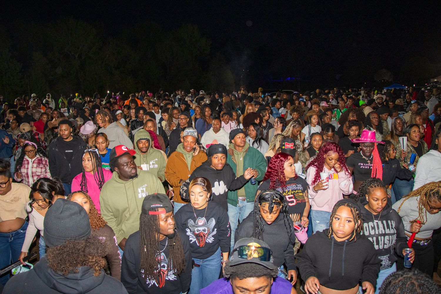 Large crowd gathered at an outdoor nighttime event.