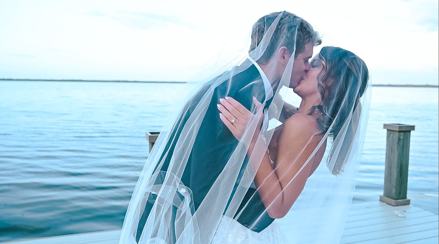 A romantic waterfront scene with soft lighting and ocean views.