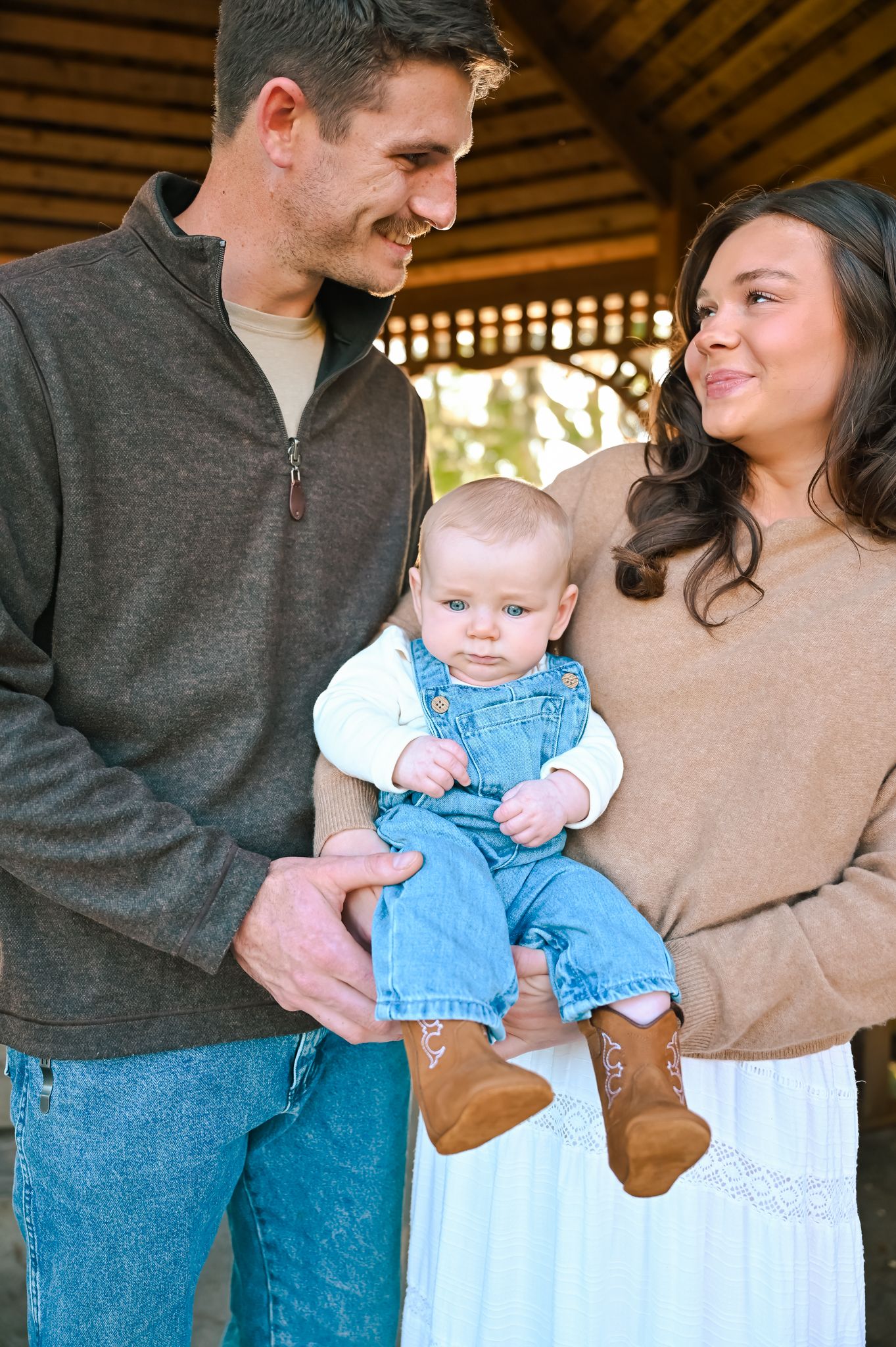 A series of intimate family moments captured under a rustic wooden structure.