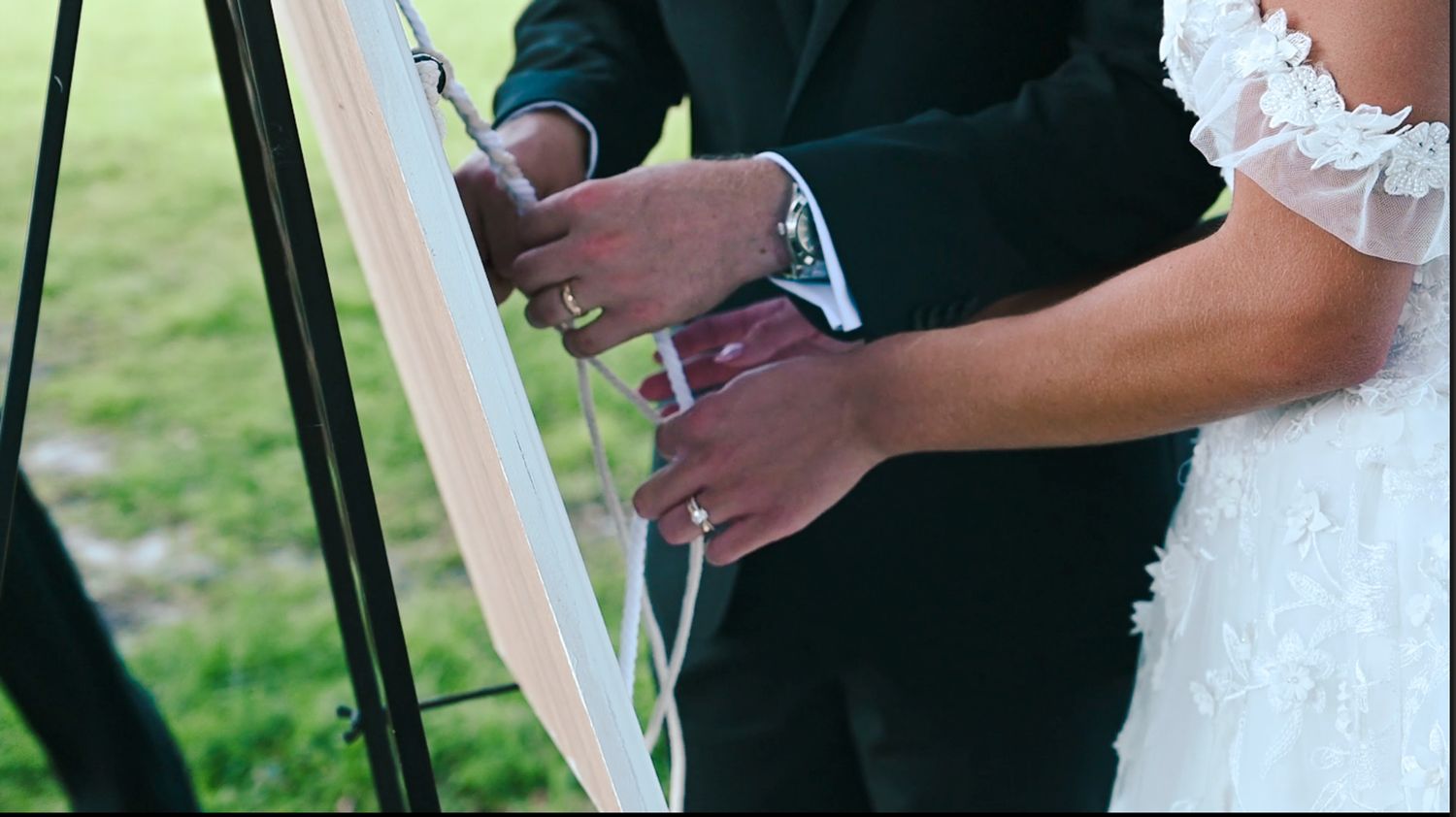 Close-up detail of formal attire at an elegant wedding ceremony.