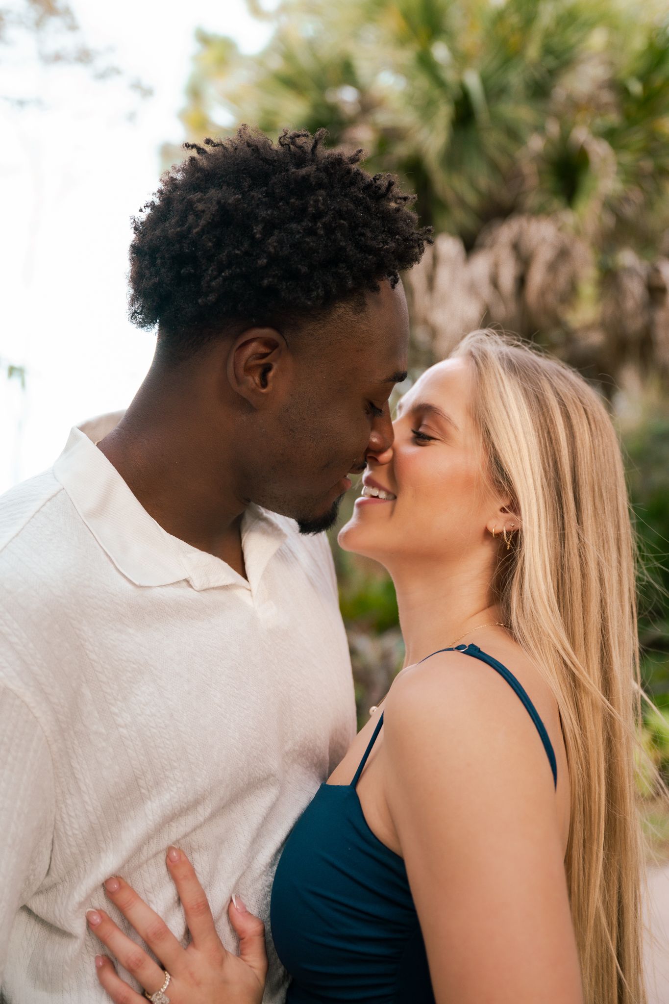Intimate couple portrait session showing tender moments against tropical background.