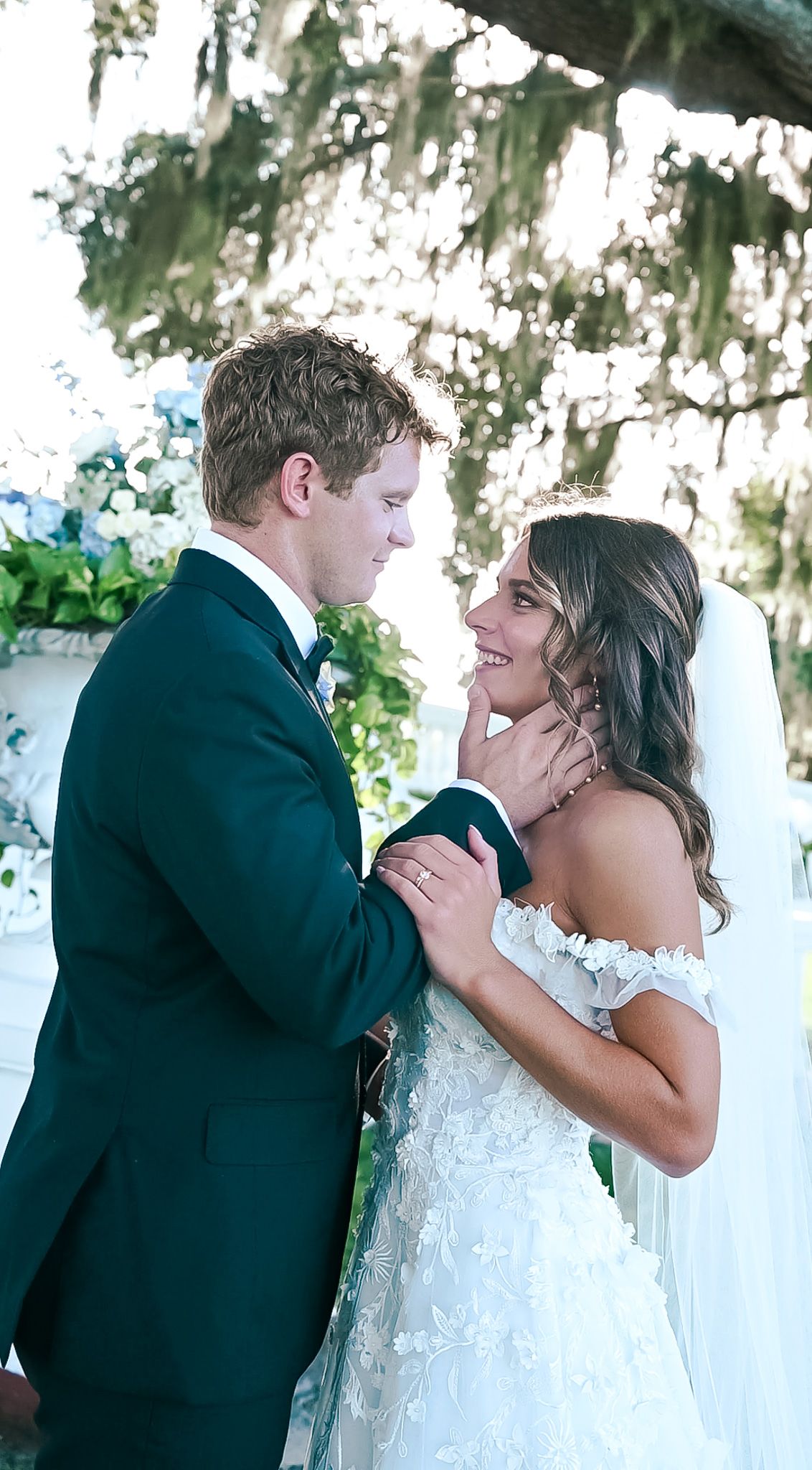 Romantic wedding couple embracing in a series of intimate poses under Spanish moss.