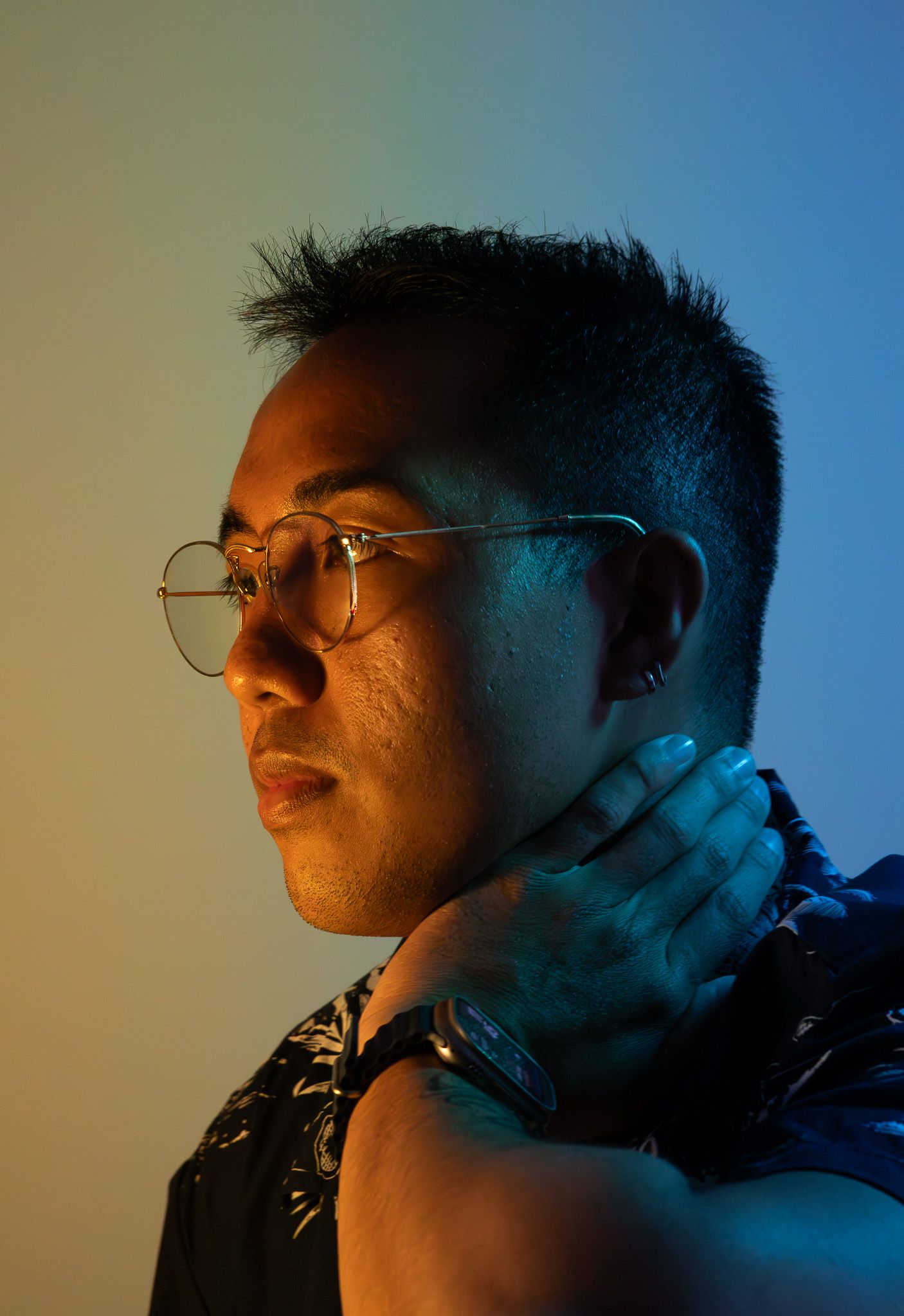 Moody profile portraits with blue lighting and glasses in sequence.