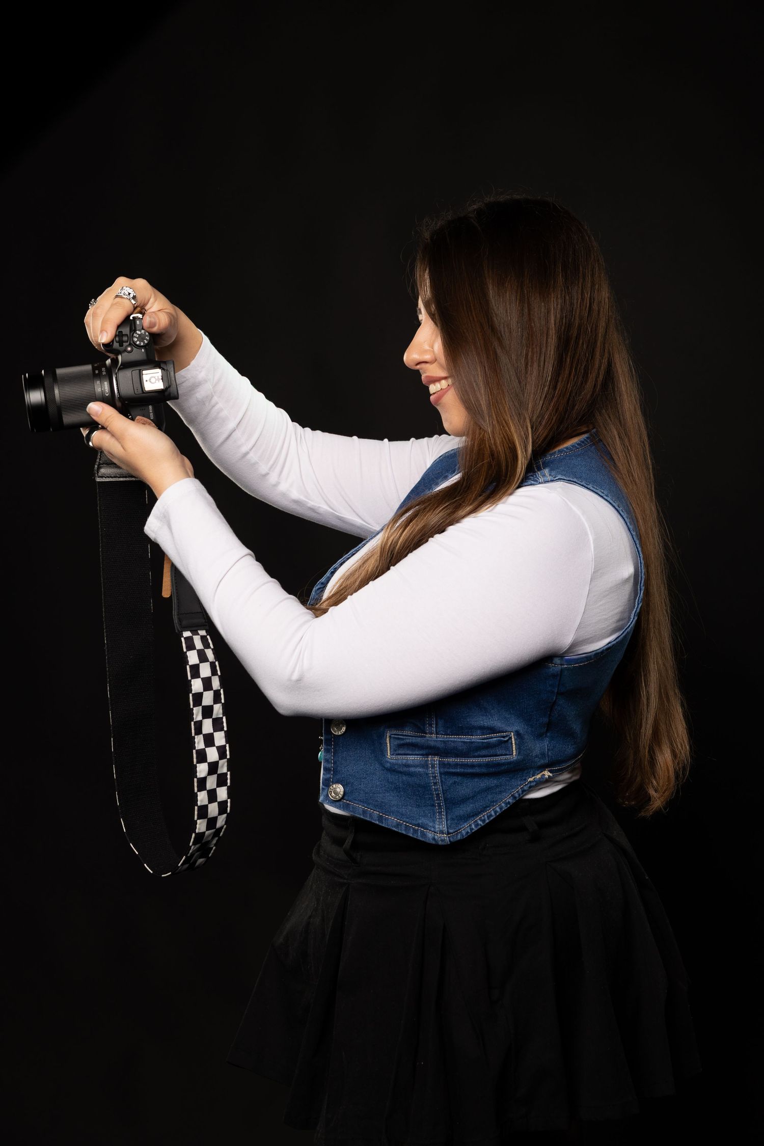 Sequence showing photographer in denim vest holding camera against black background.