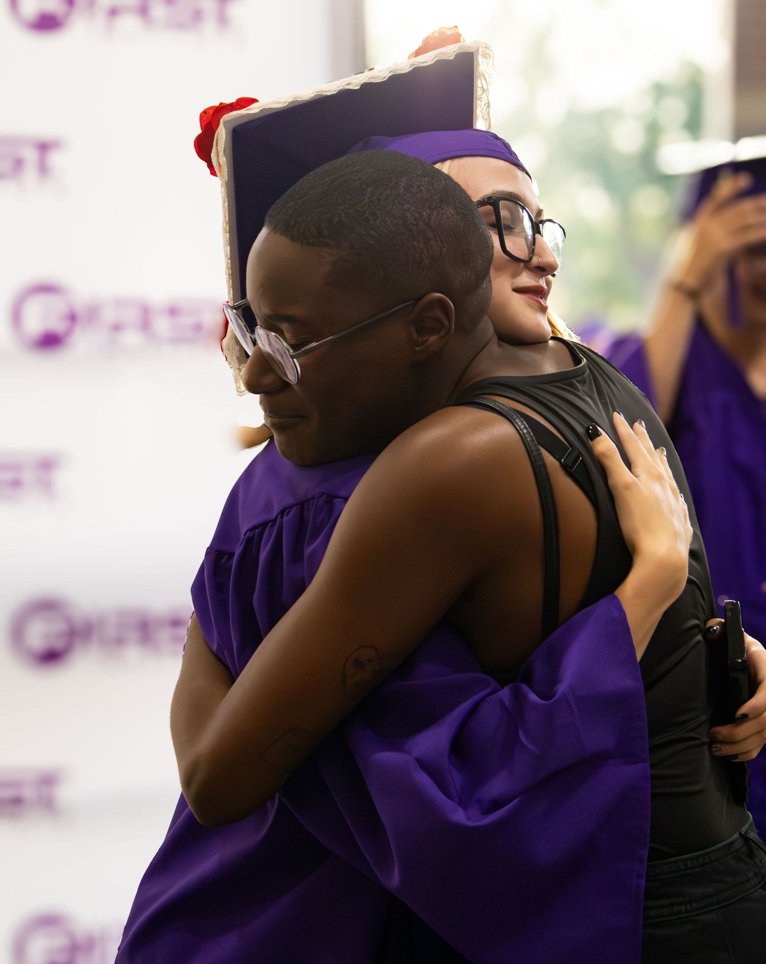 A series of photos showing two people in purple and black clothing embracing in an emotional sequence.
