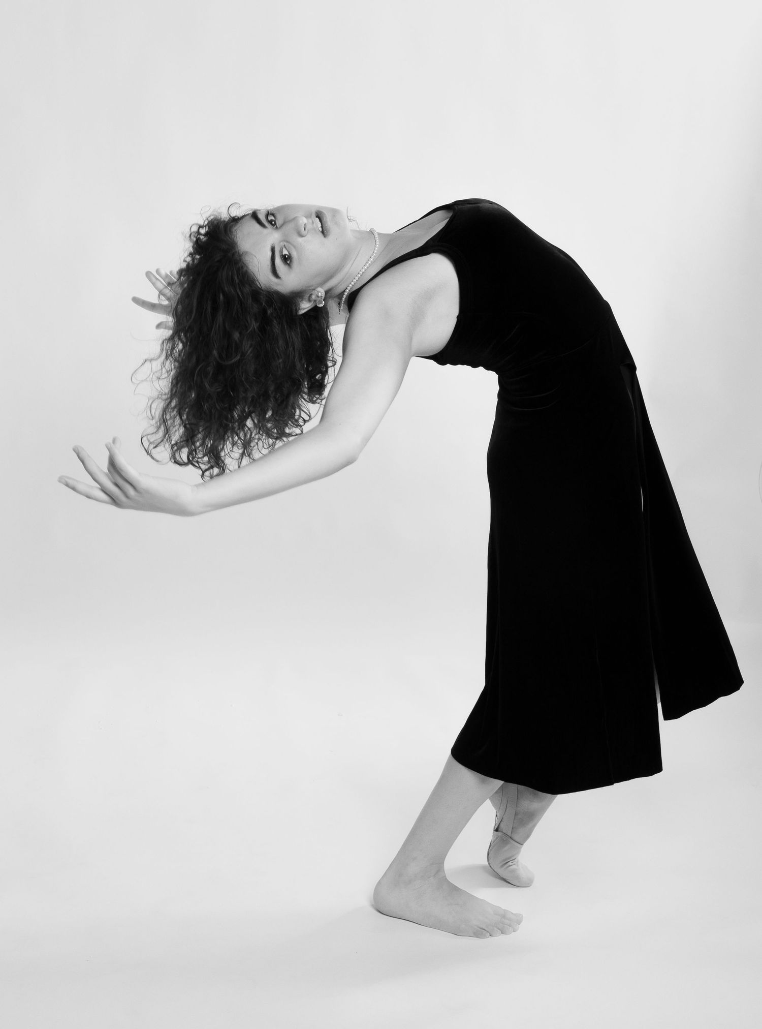Black and white sequence showing graceful dance movements in minimal setting.