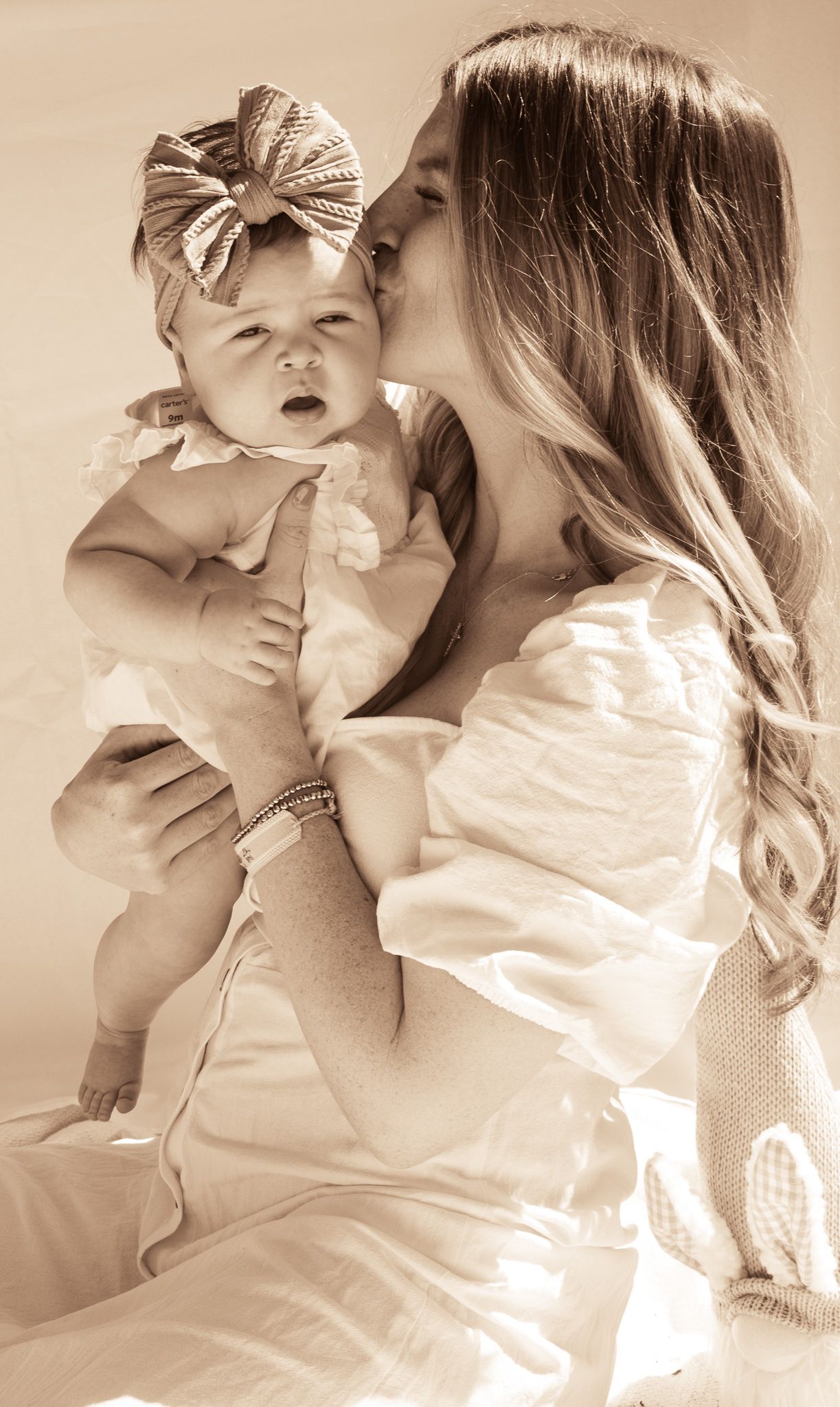 Sepia-toned sequence showing tender moments with an infant.