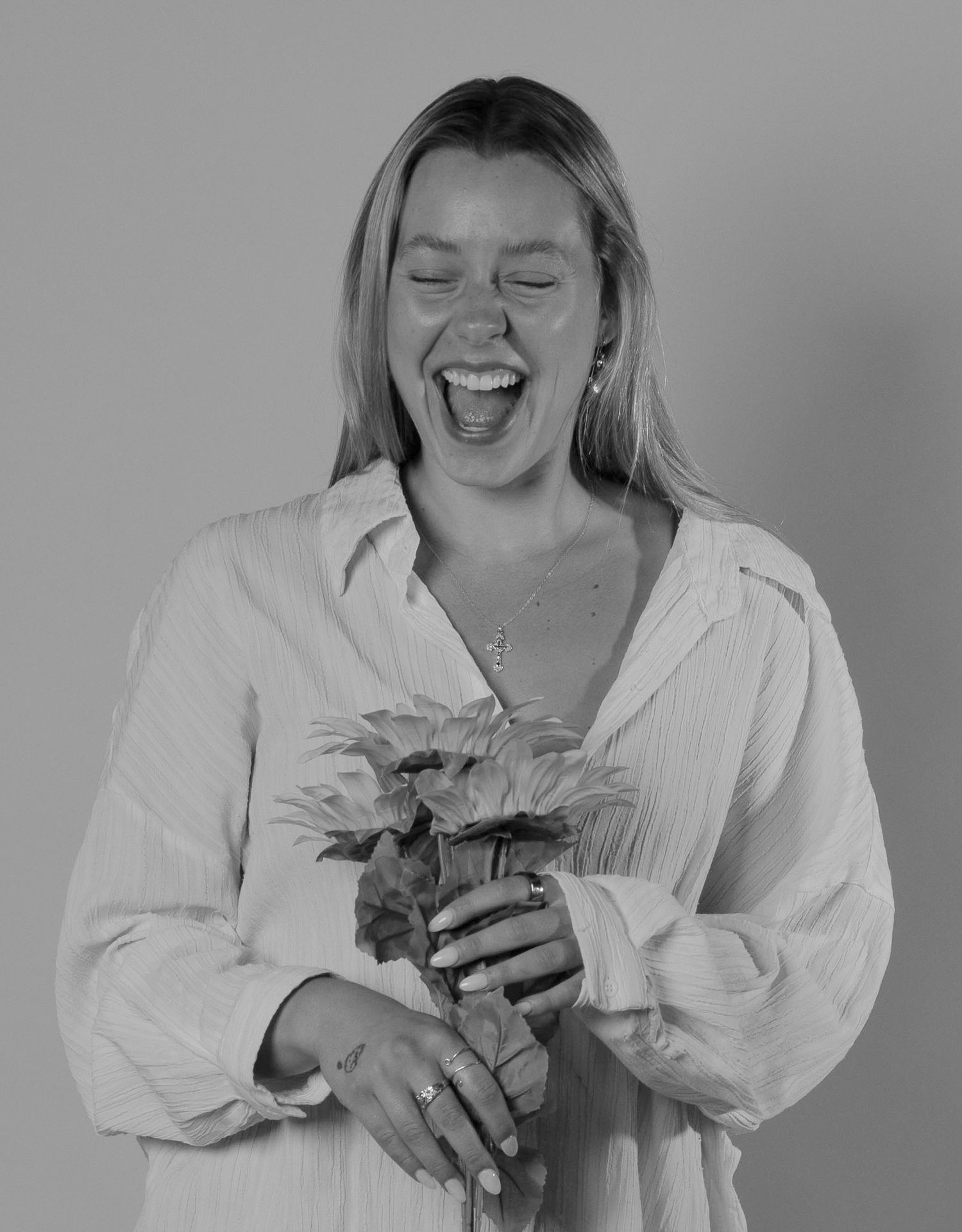 Black and white sequence showing joyful moments with flowers.