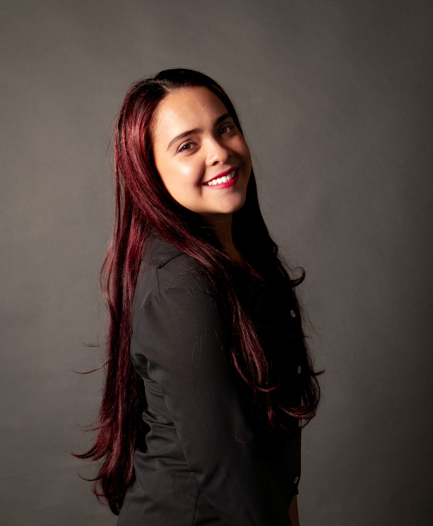 Portrait sequence showing movement with red hair against dark background.