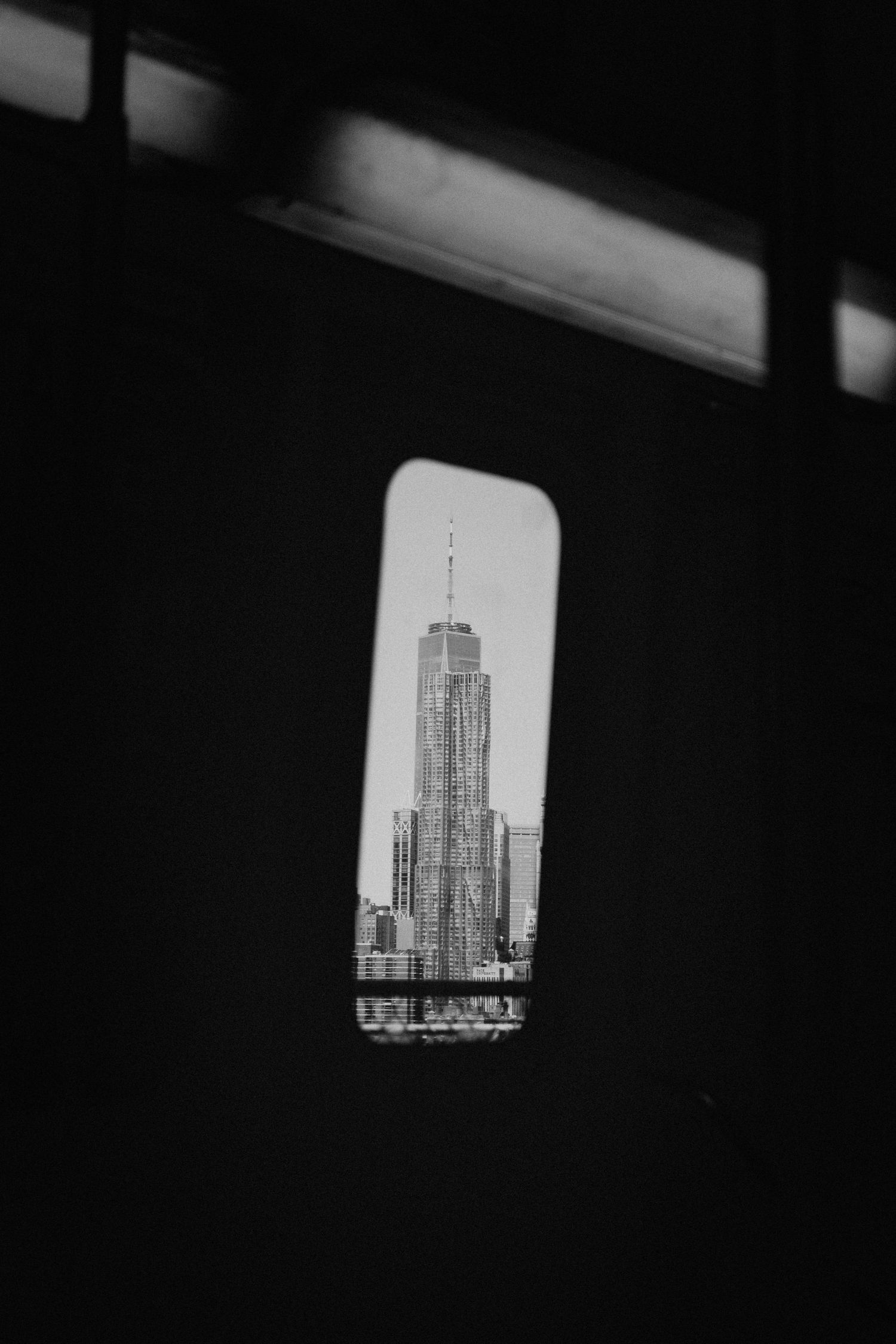 Black and white architectural photos showing skyscraper views through window frames.