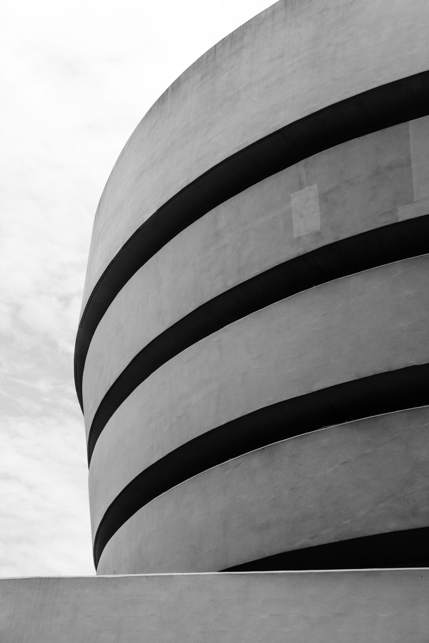 Minimalist black and white architectural detail of the Guggenheim Museum's distinctive spiral exterior.