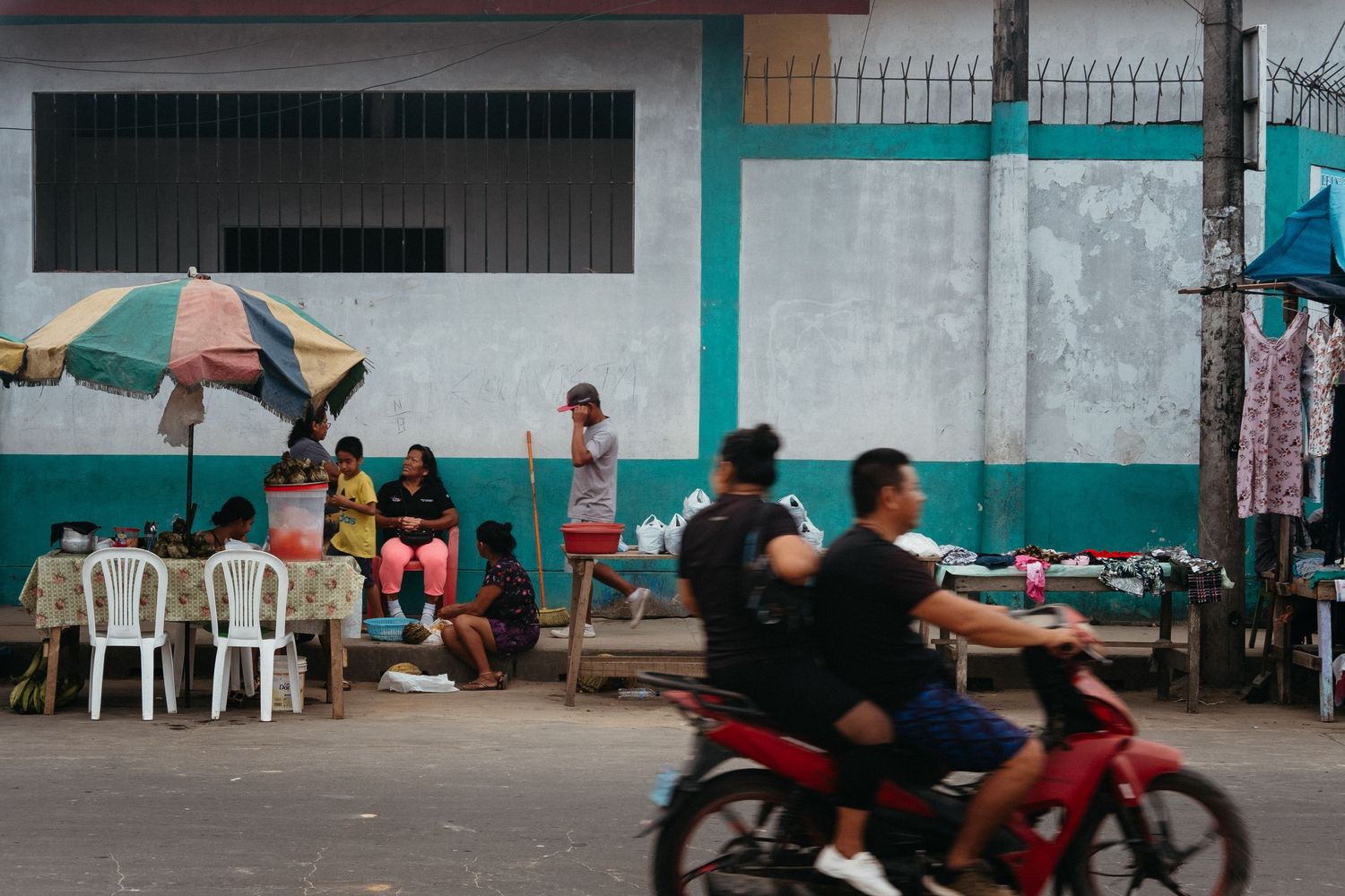 Street view of simple buildings with turquoise and white painted walls.