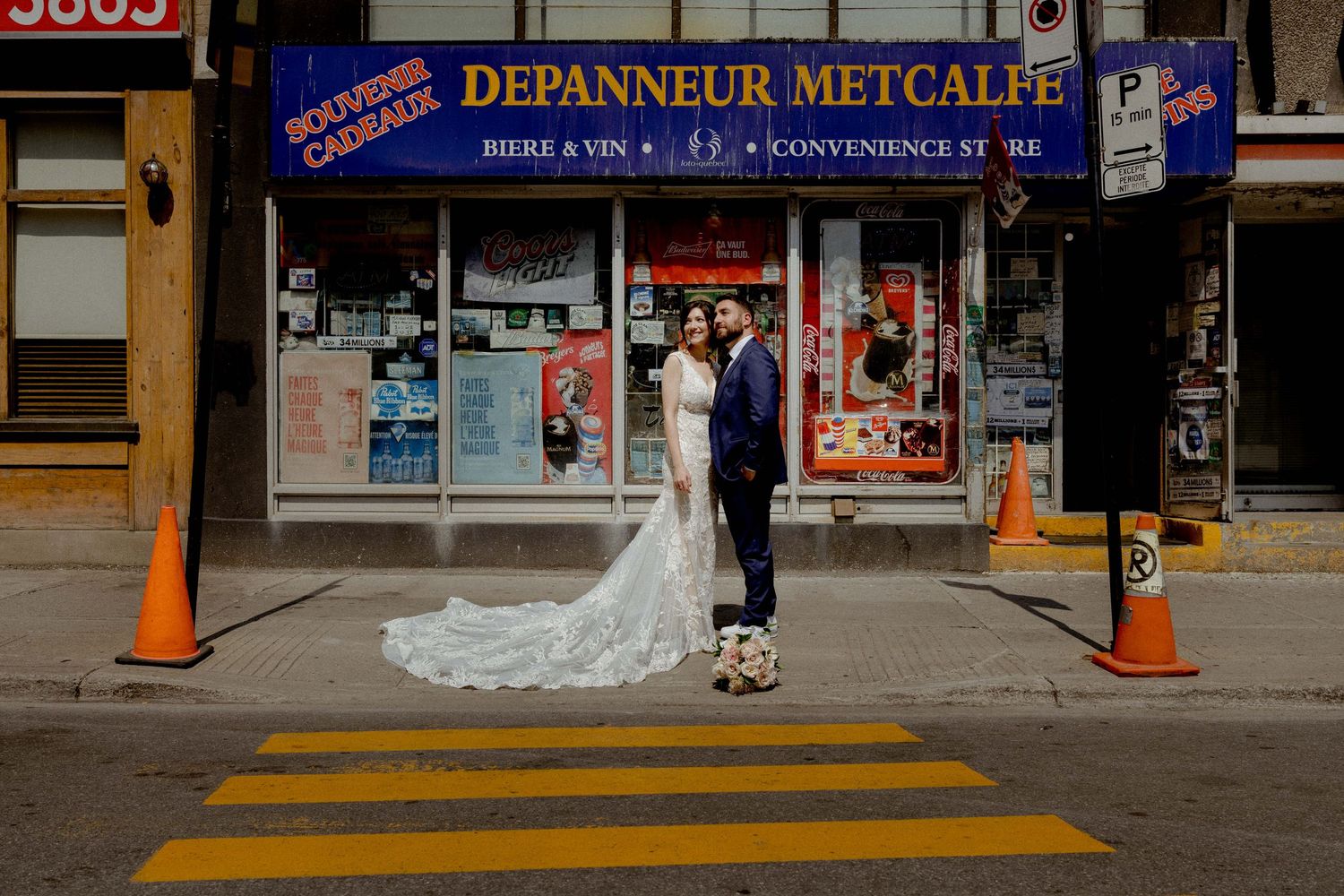 Wedding photos captured in front of urban storefronts with orange traffic cones.