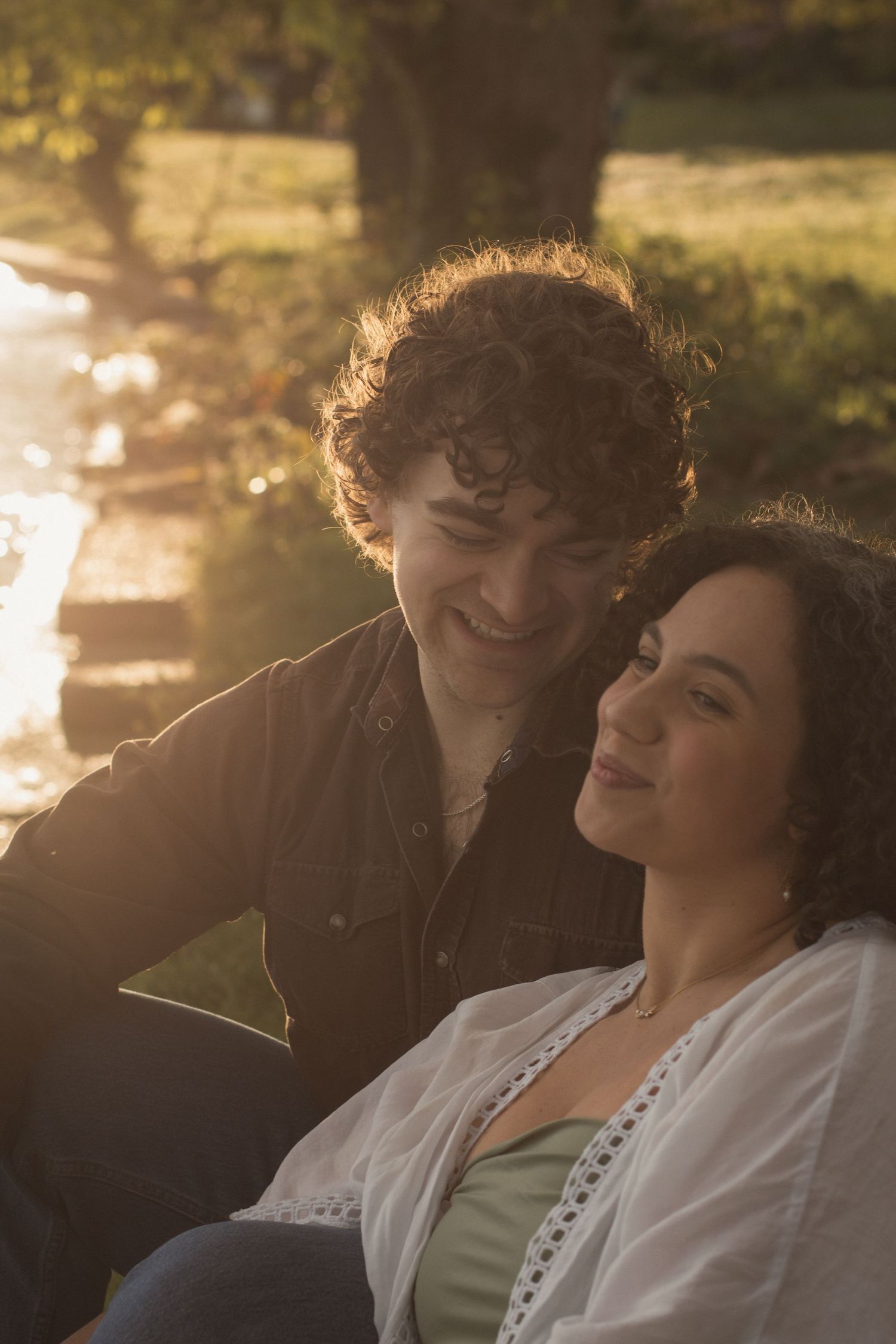 Cinematic Photo Memory of a couple sitting by the water in Seattle, Washington and smiling and enjoying the moment