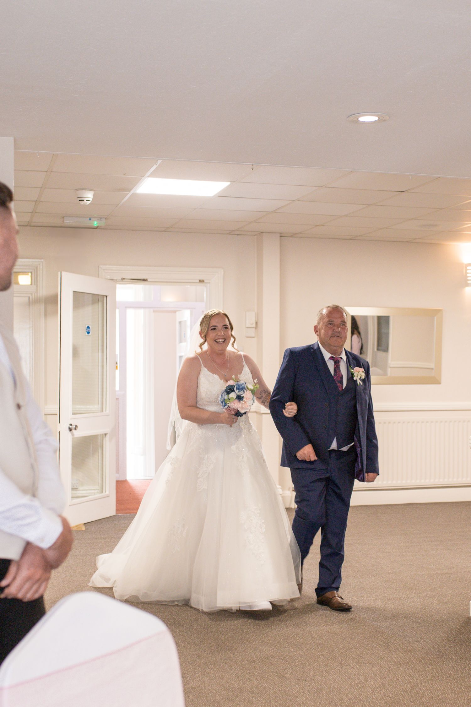 Bride and her father walk down the aisle together at the Hotel Rembrandt