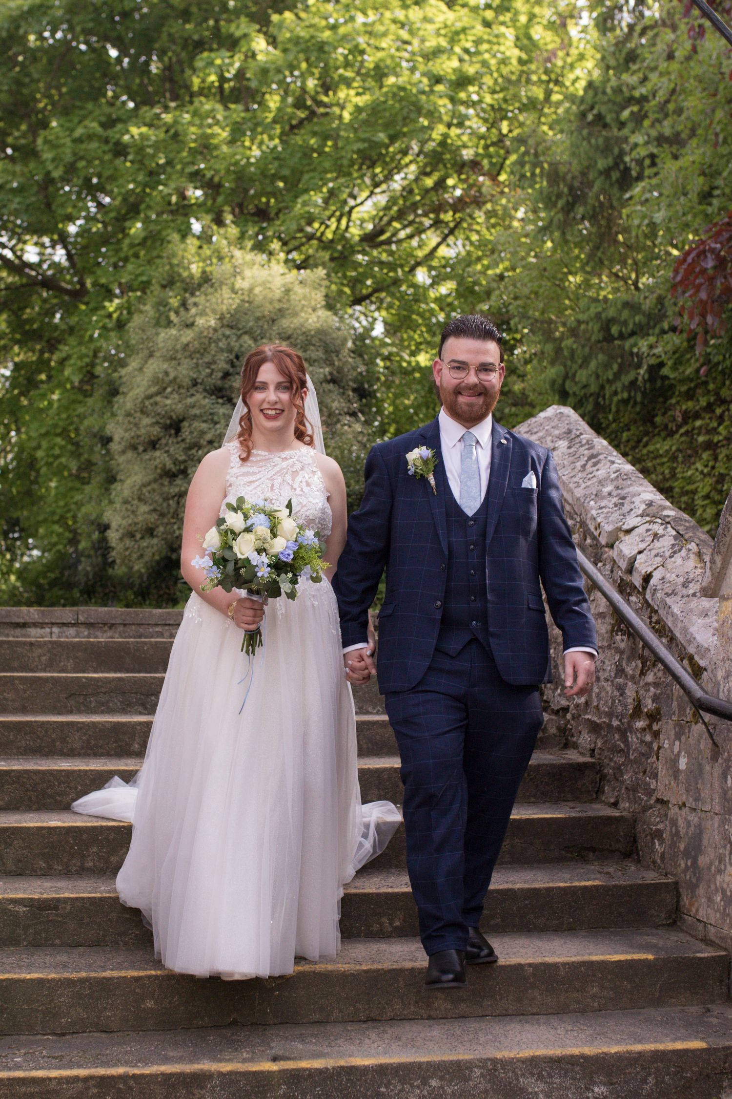 Bride and Groom walking down steps after their church ceremony.