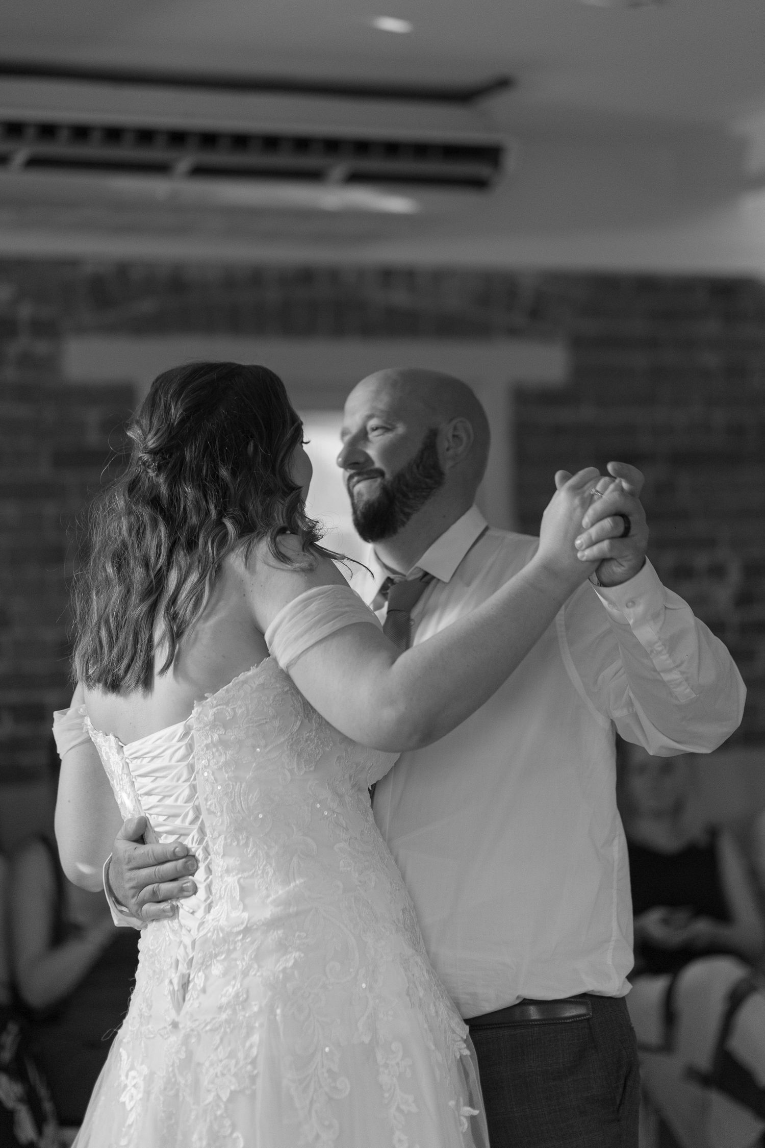 Black an White photo of a bride and groom sharing their first dance