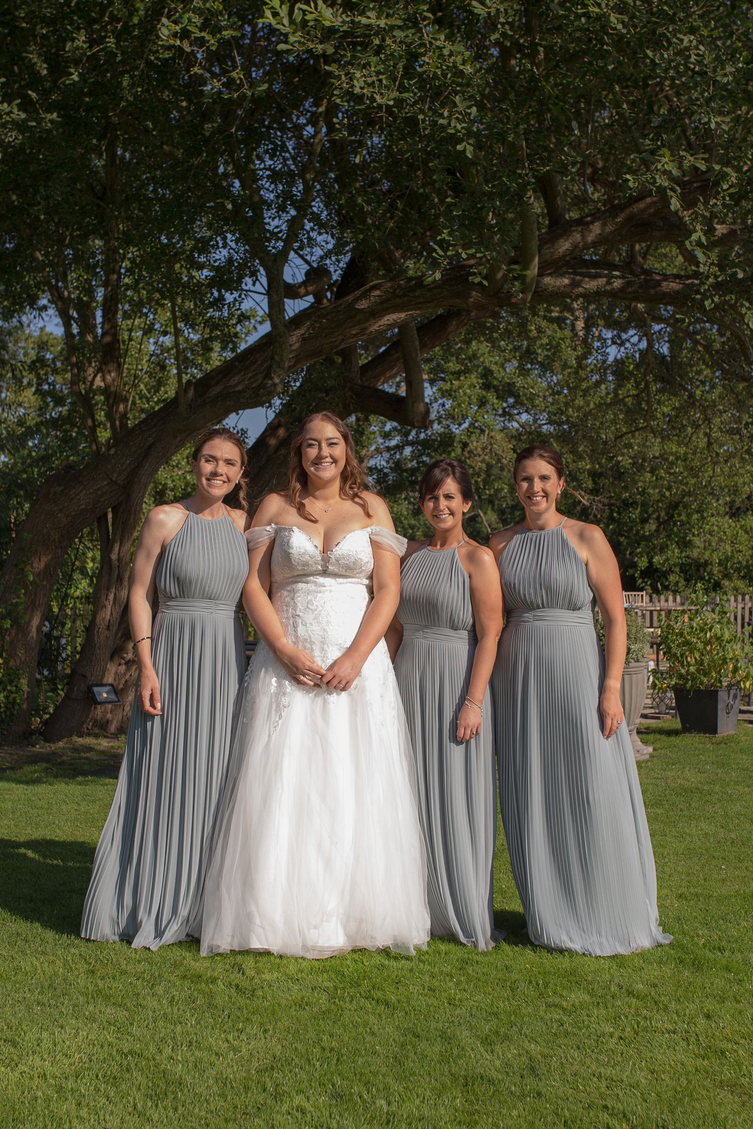 Bride poses for a group photo with her three bridesmaids