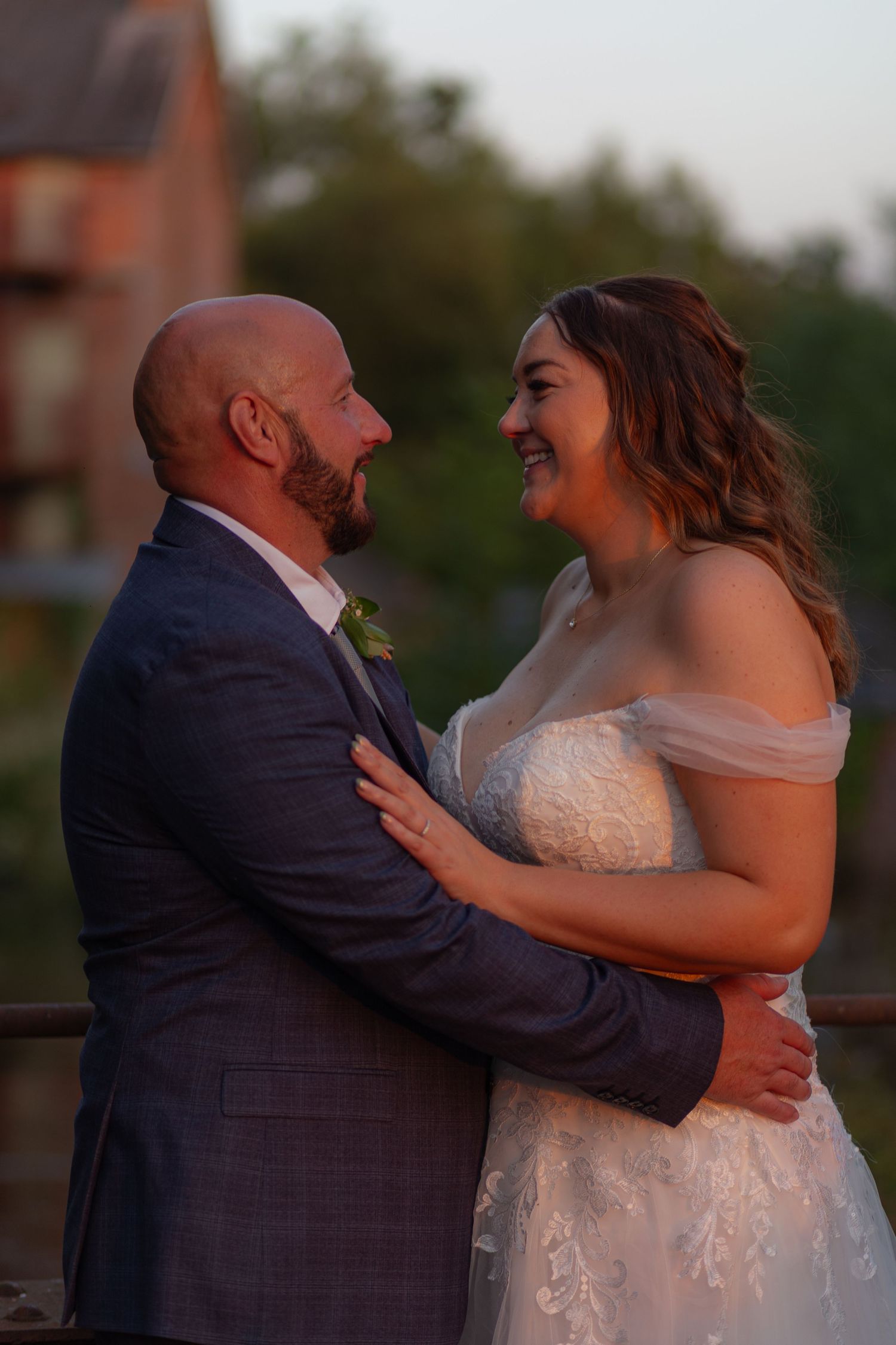 Bride and Groom sharing an embrace, smiling away at each other