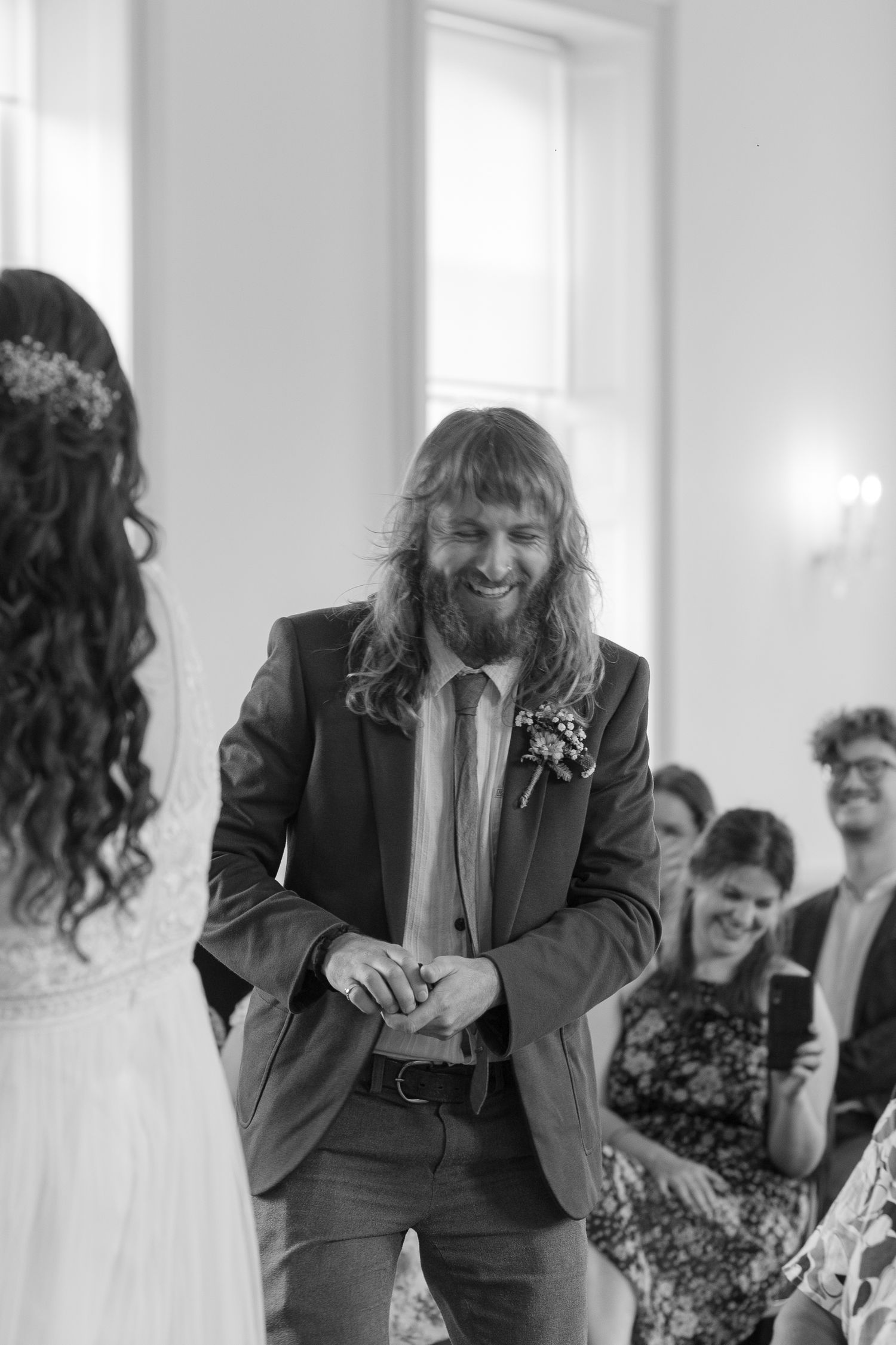 Best Man walking to the front of the wedding to deliver the ring box to the couple