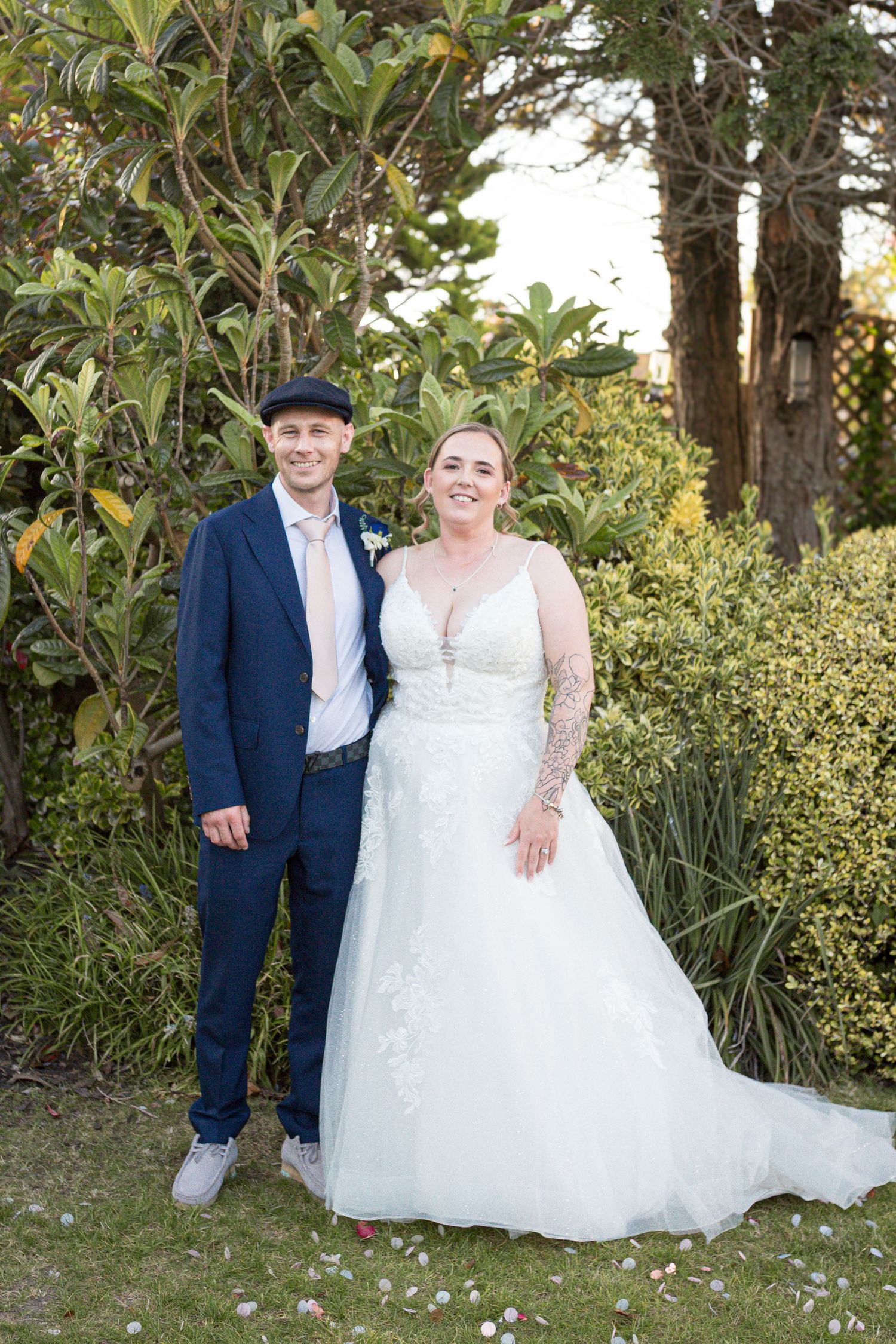 Bride and Groom pose together smiling for a traditional wedding portrait.